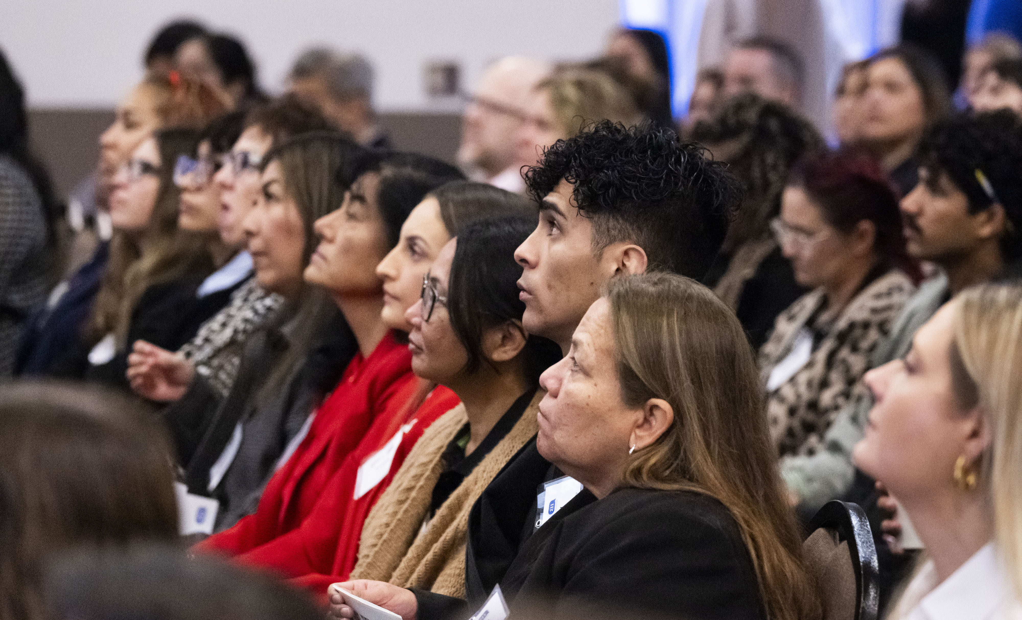 Audience members listen to speakers during The Pulse of Orange...