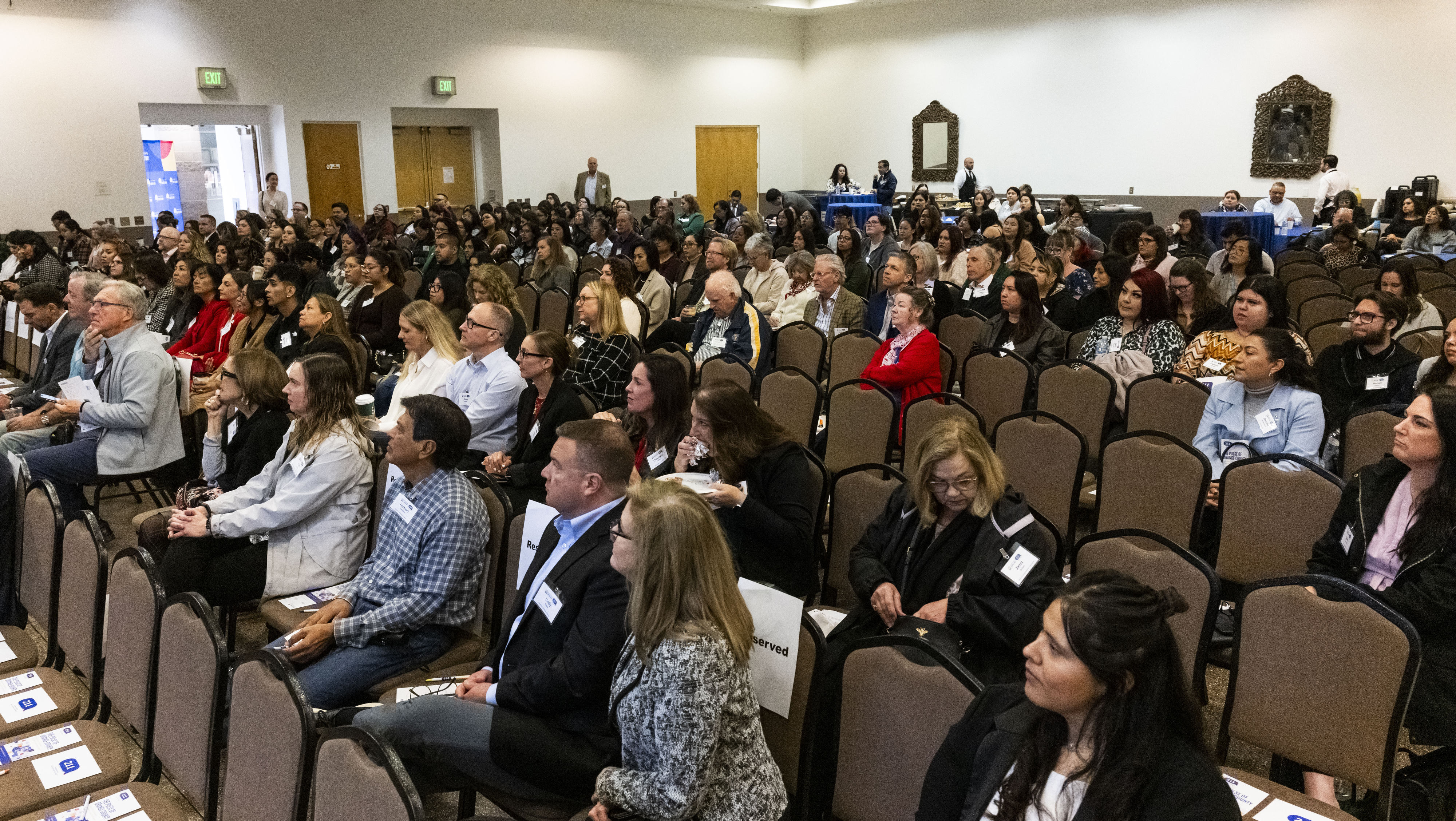 Audience members listen to speakers during The Pulse of Orange...