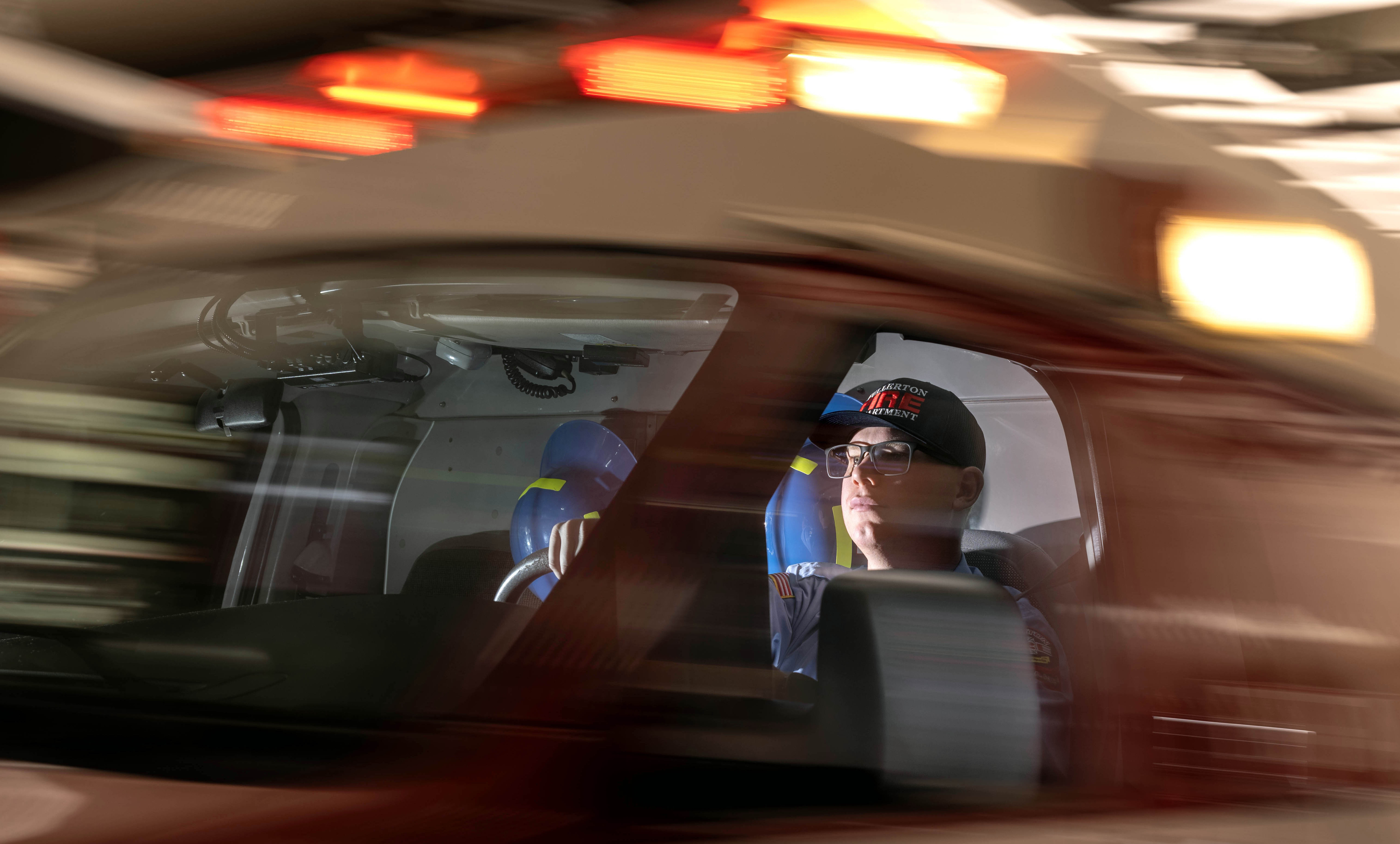 Fullerton Fire Department ambulance operator Patrick Manfredi sits inside an...