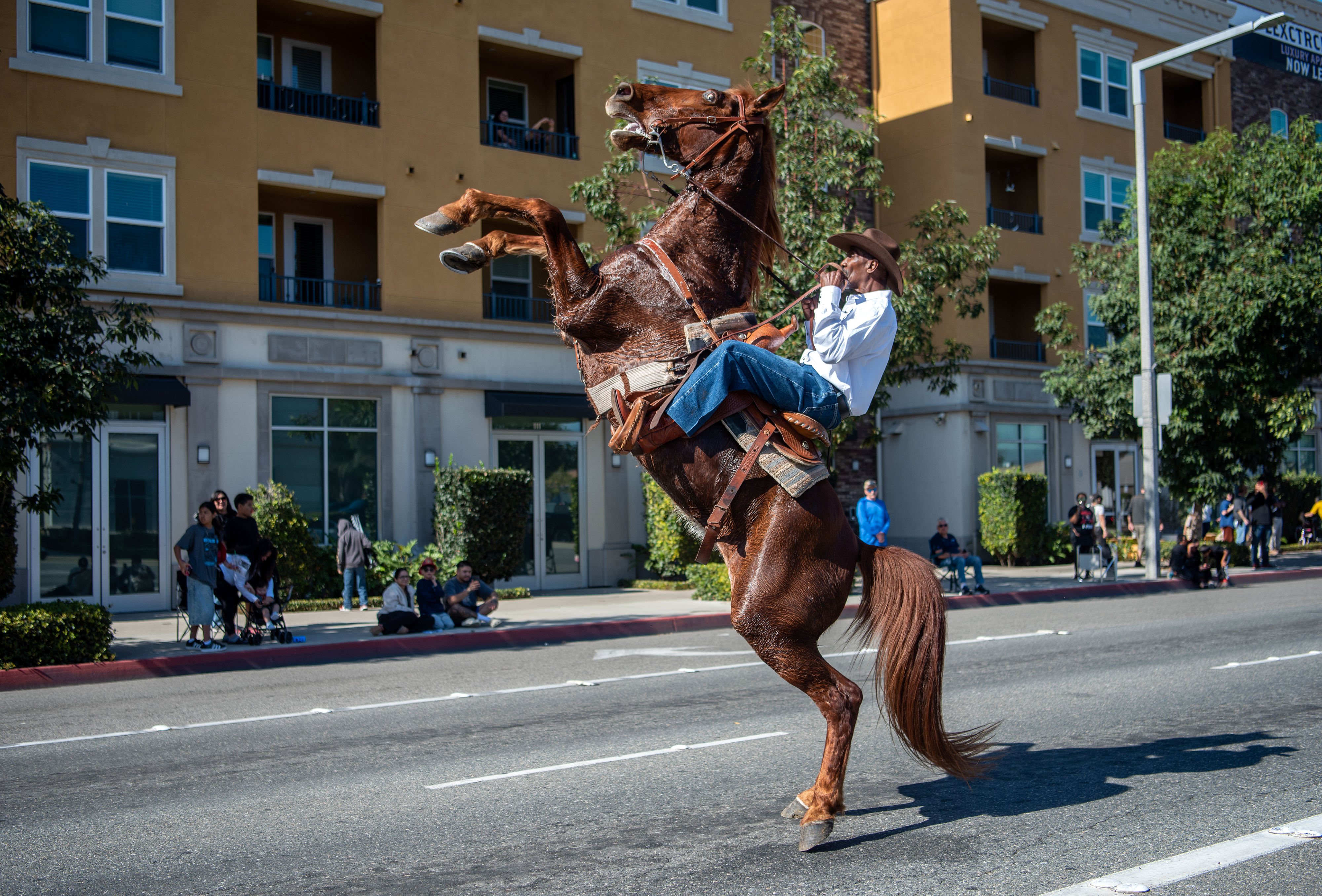 Mike Jones, riding with the group Urban Saddles, does tricks...