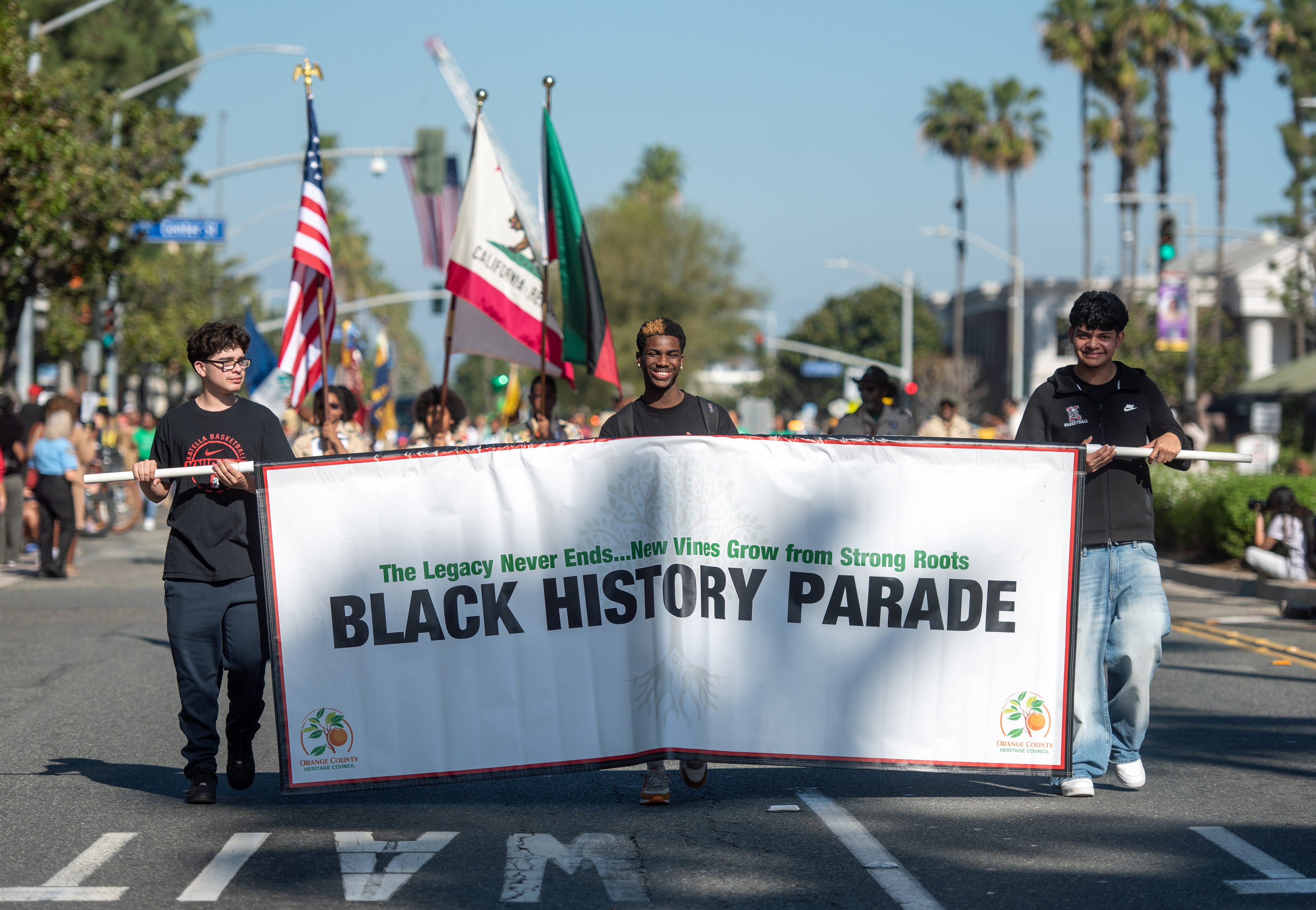 Participants carry the lead banner for the 46th annual Orange...