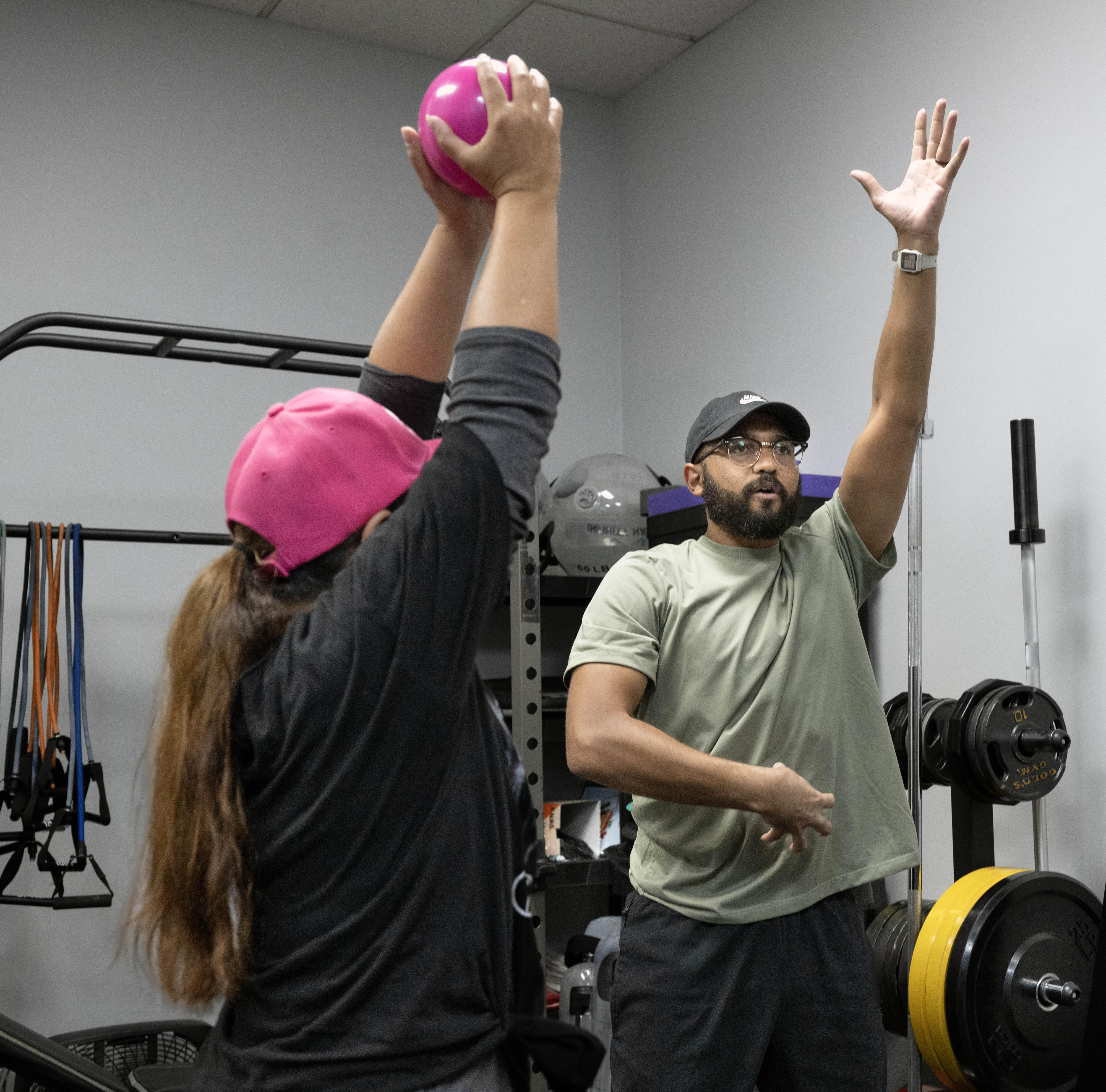 Strength Coach Chris Henderson works with clients at the Families...