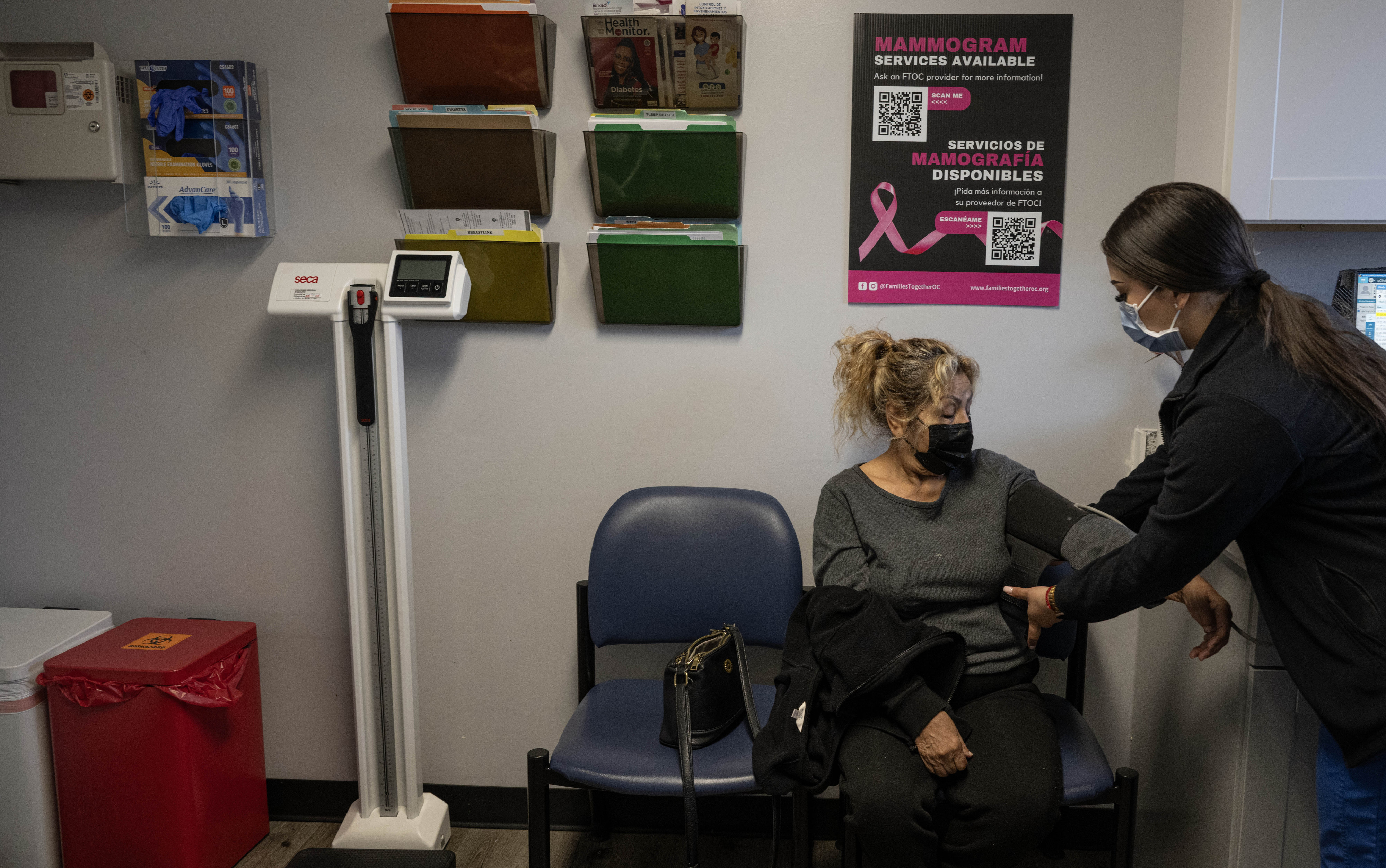 Medical assistant Kim Oviedo checks a clientâs blood pressure at...