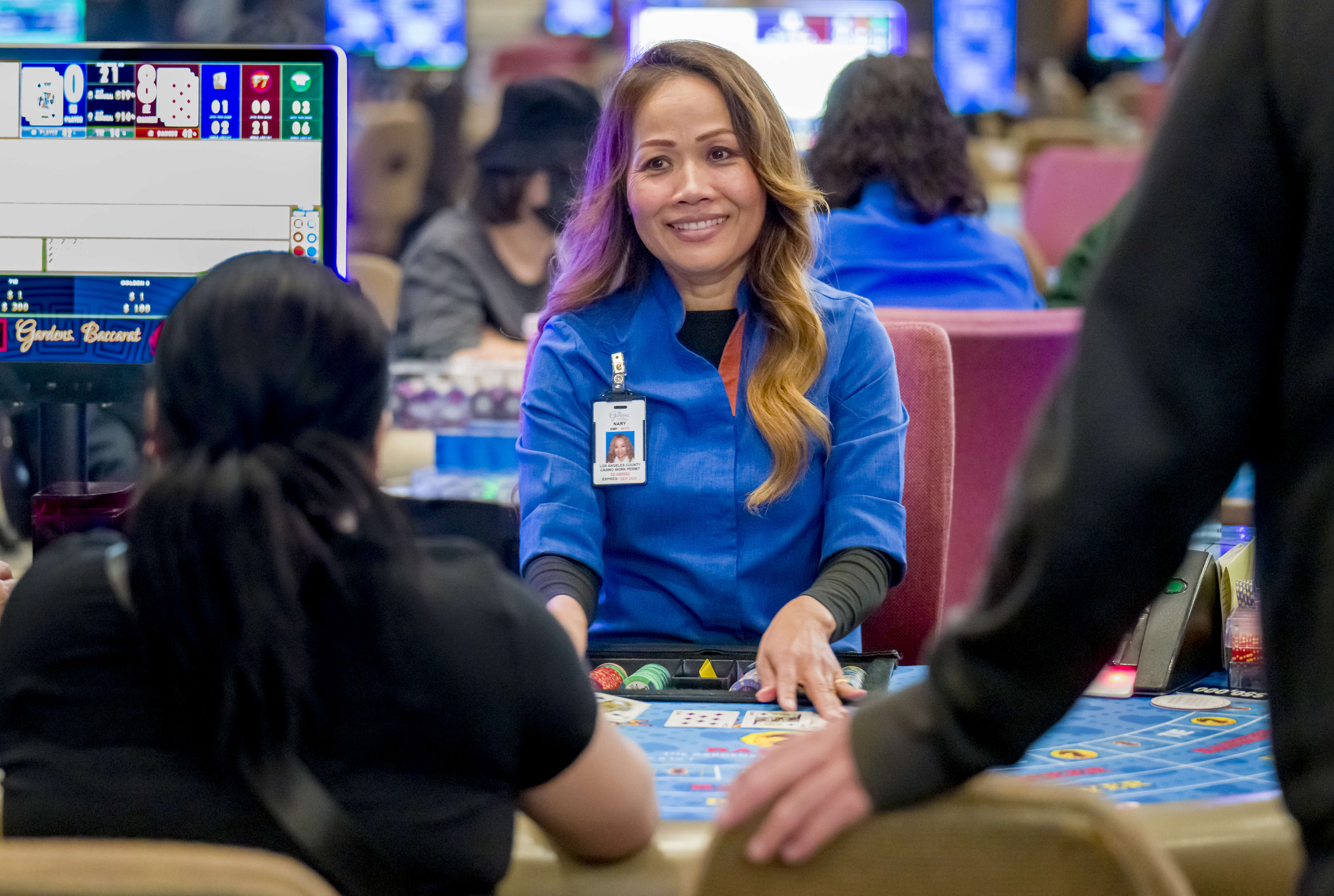 Nary Chin deals cards for a Baccarat game at The...