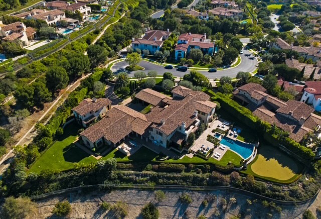 An aerial view of a Tuscan farmhouse-style estate in Newport...