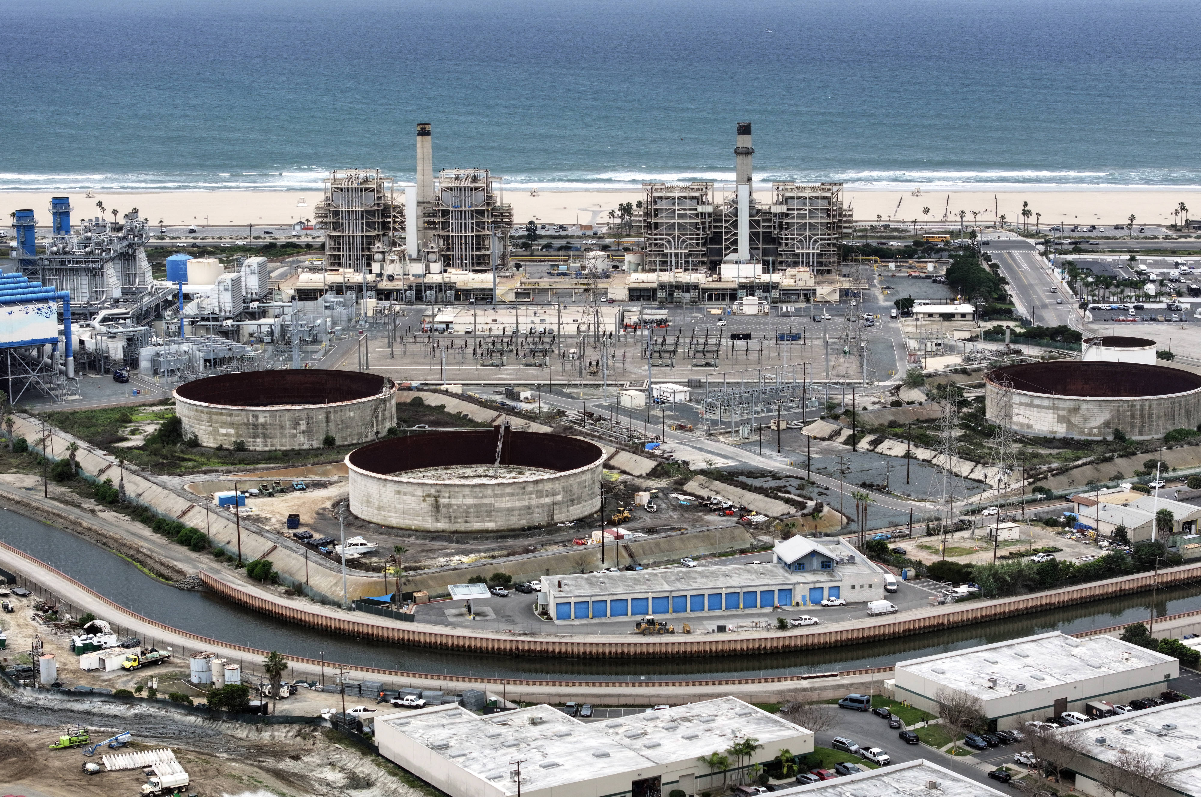 Tanks sit behind the AES Huntington Beach power plant in...