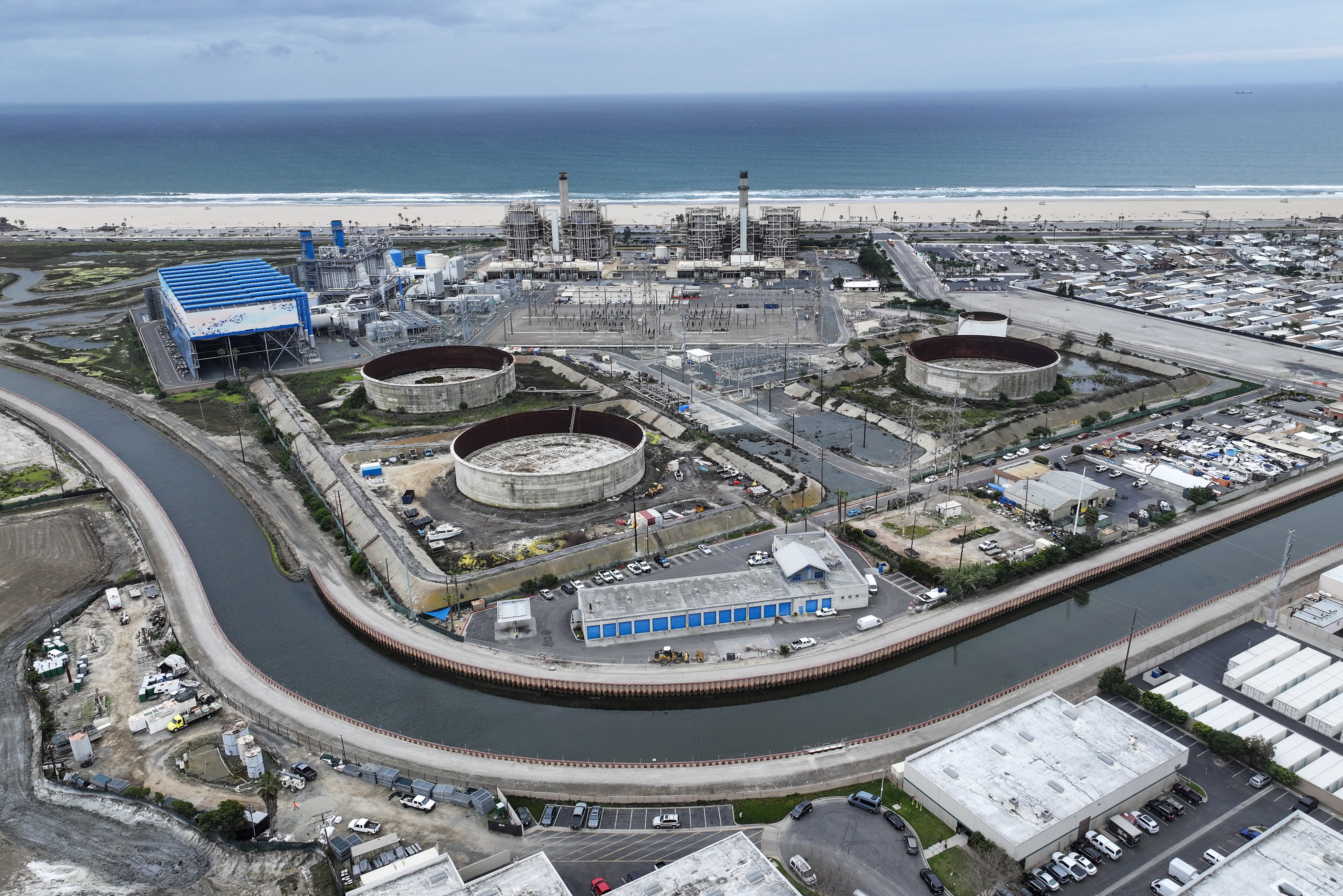 Tanks sit between the AES Huntington Beach power plant and...