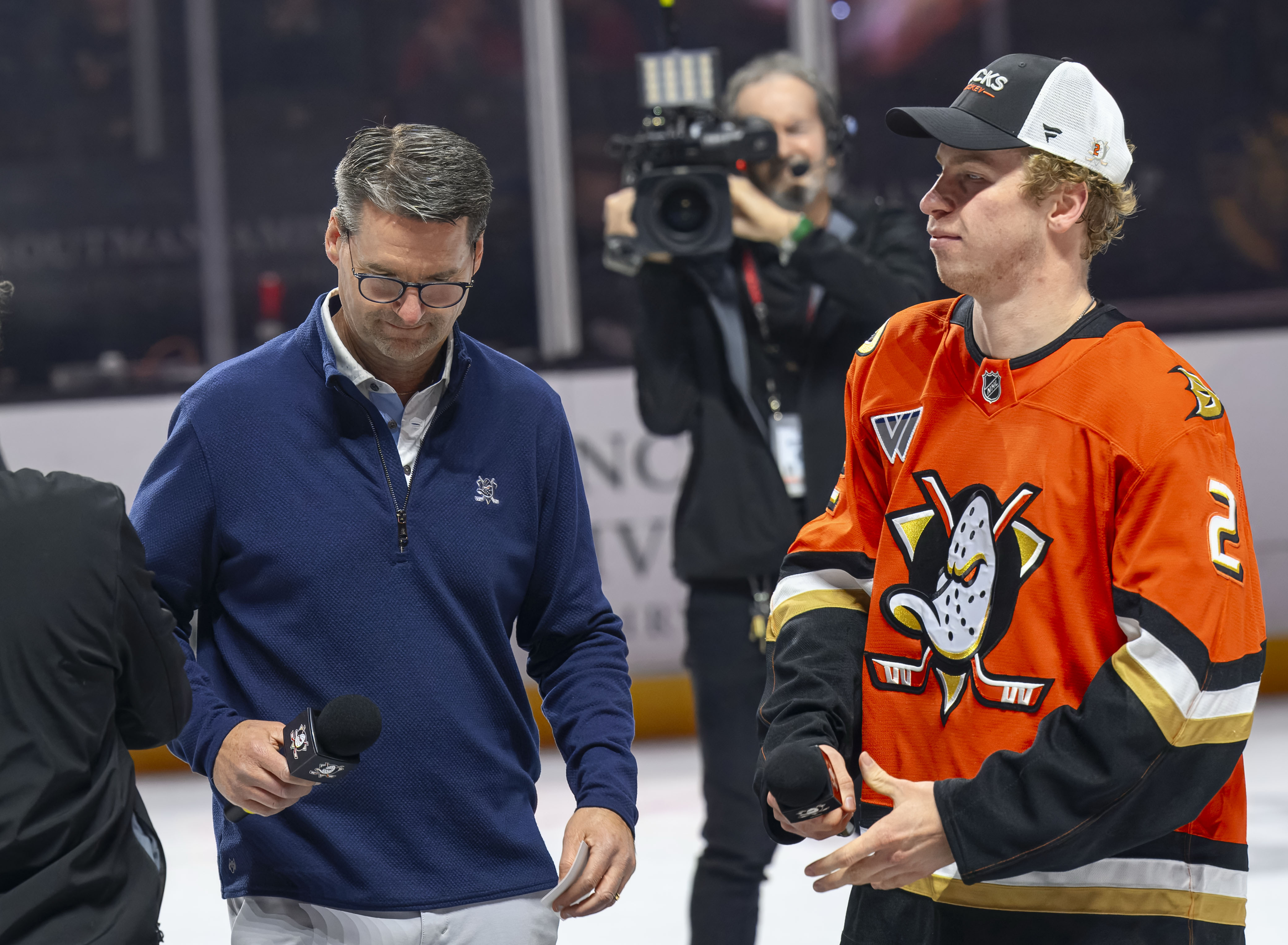 Anaheim Ducks president Aaron Teats, left, and player Jackson LaCombe,...