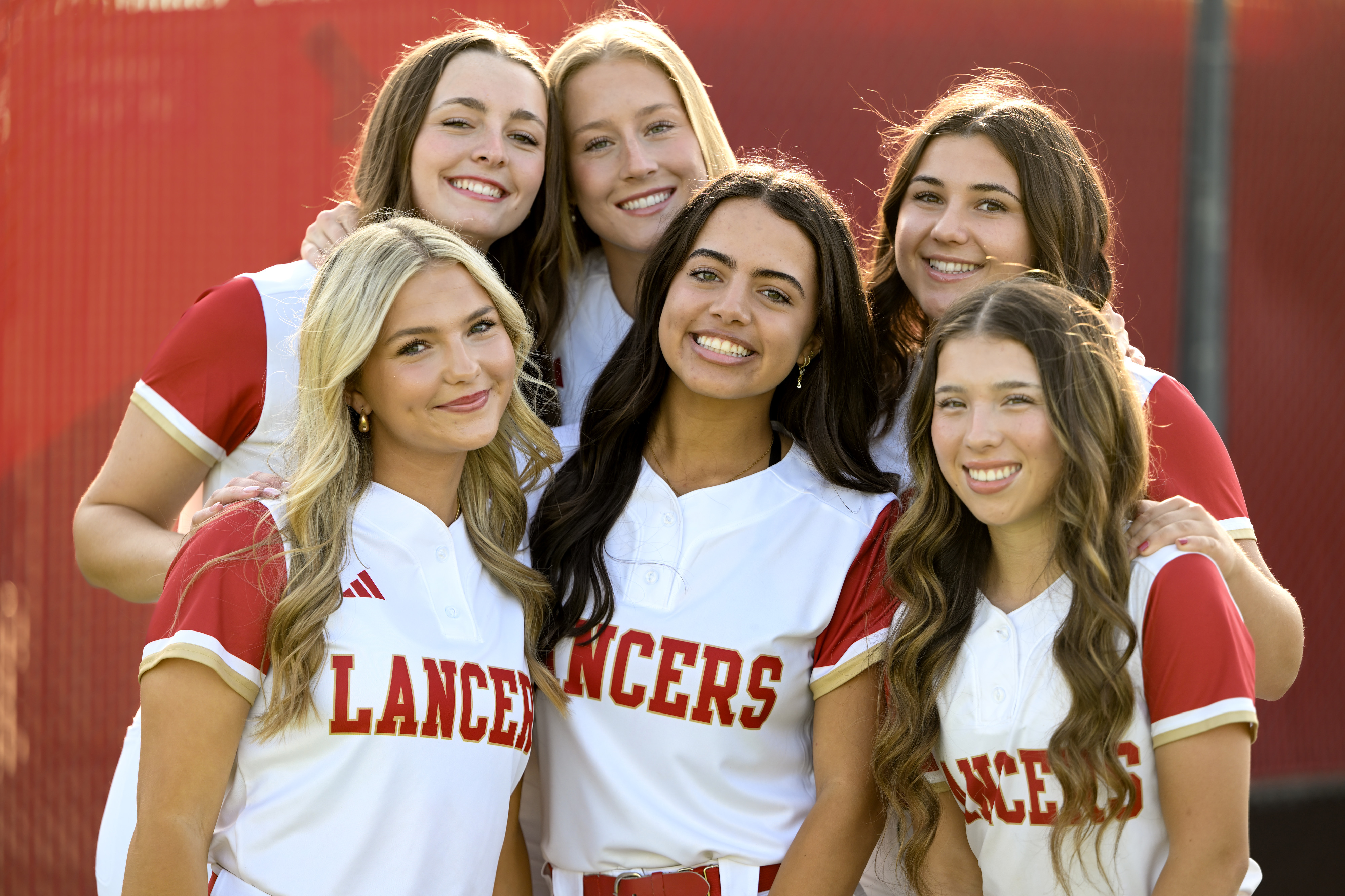 Orange Lutheran softball players, from left, Morgan Fitzpatrick, Cate Medvitz,...