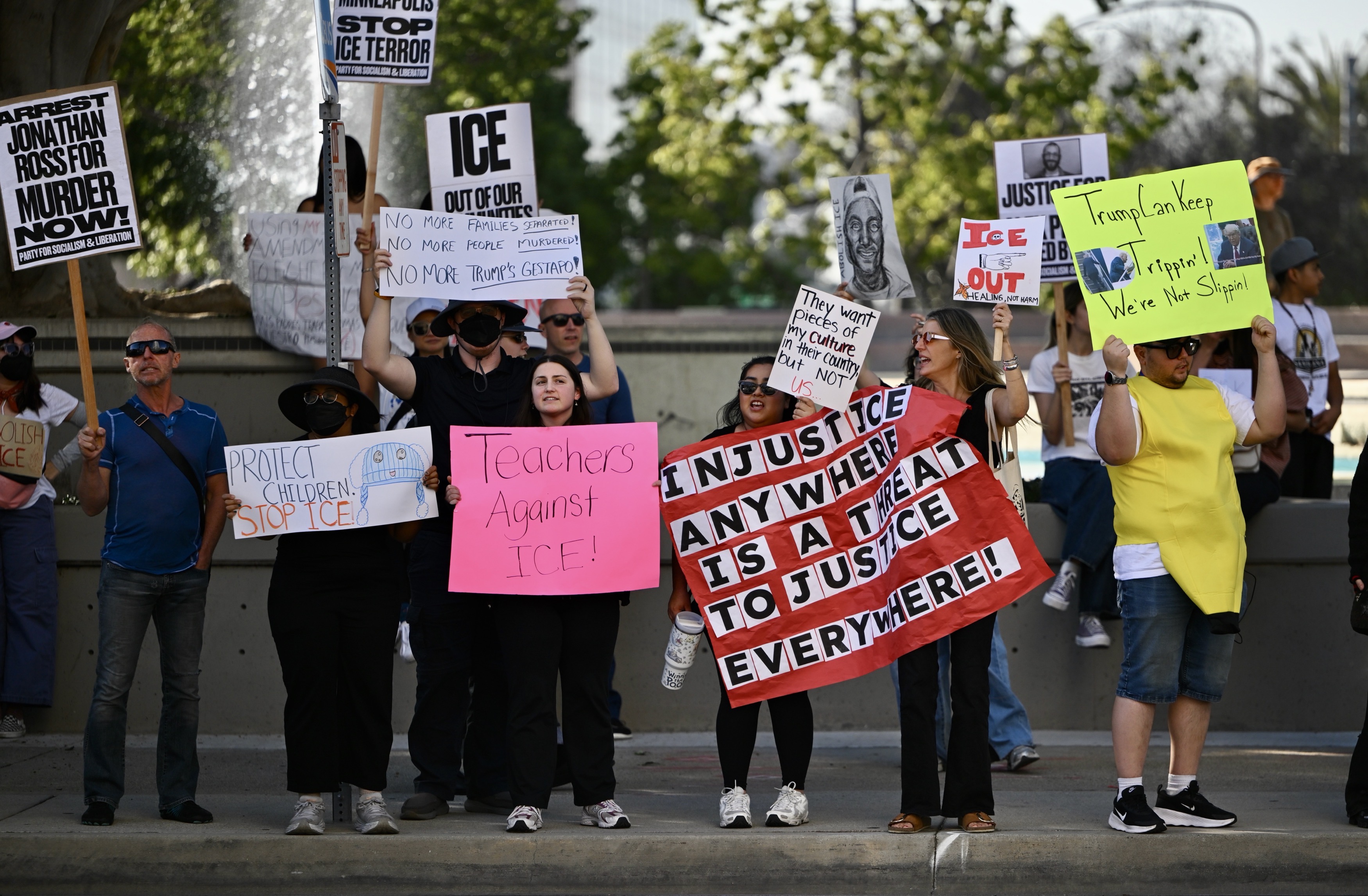 Protesters line Ross Street during a demonstration against ICE in...