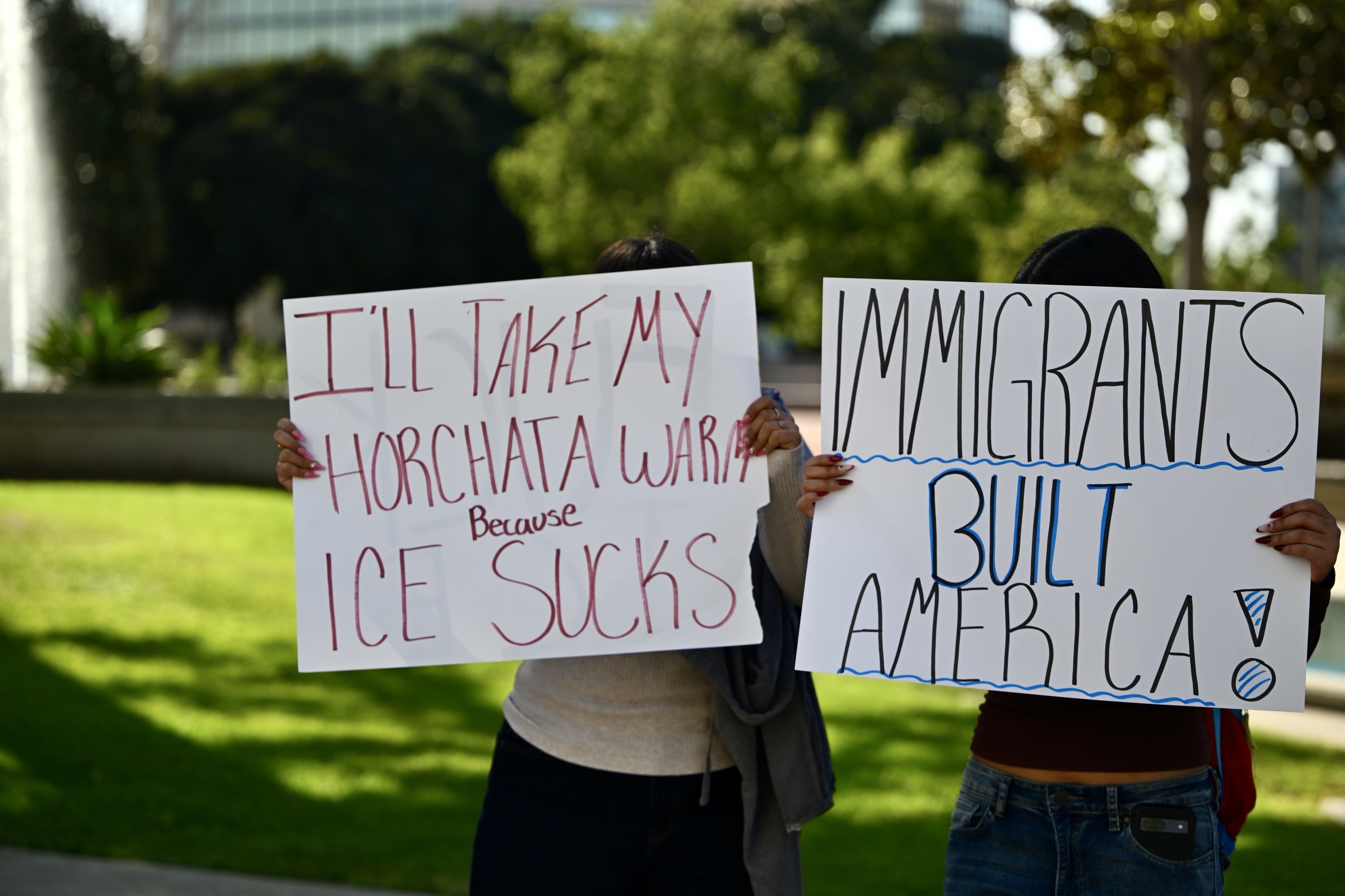 Protesters line Ross Street during a demonstration against ICE in...