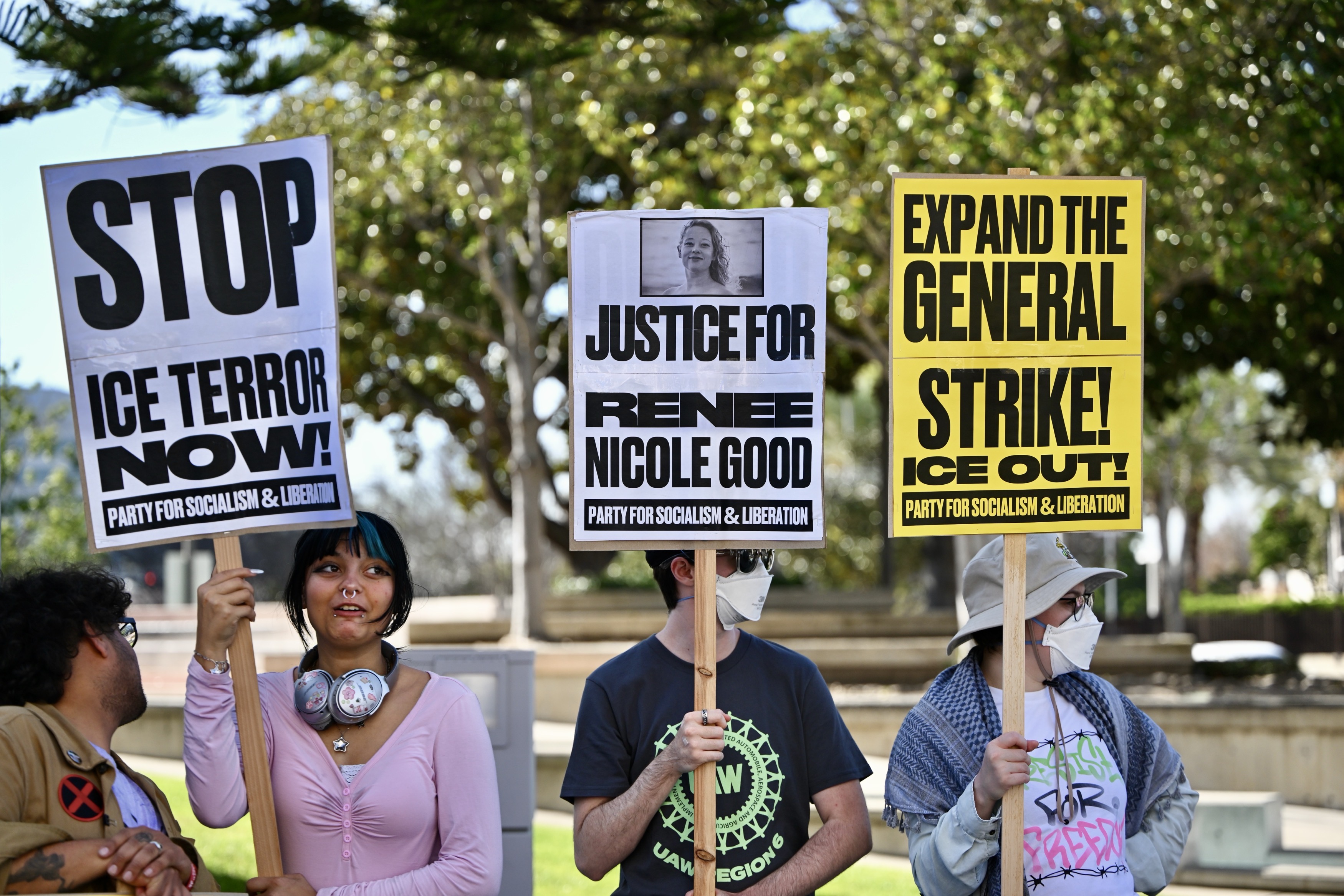 Protesters line Ross Street during a demonstration against ICE in...