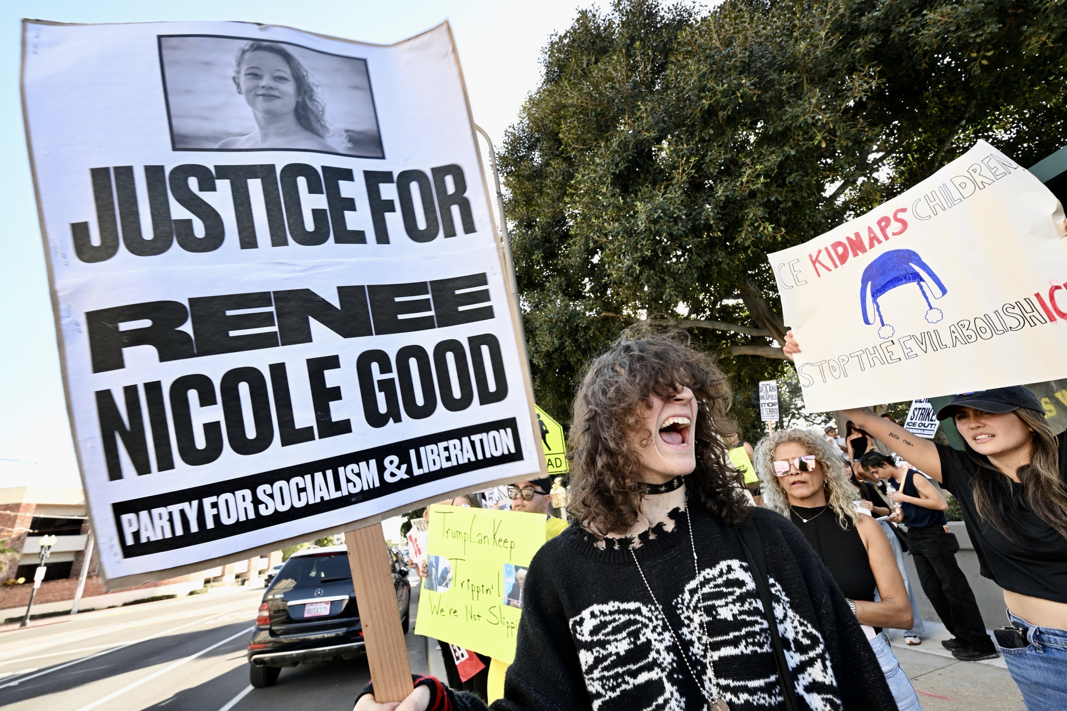 Kai Lee, from Santa Ana, responds to chants during a...