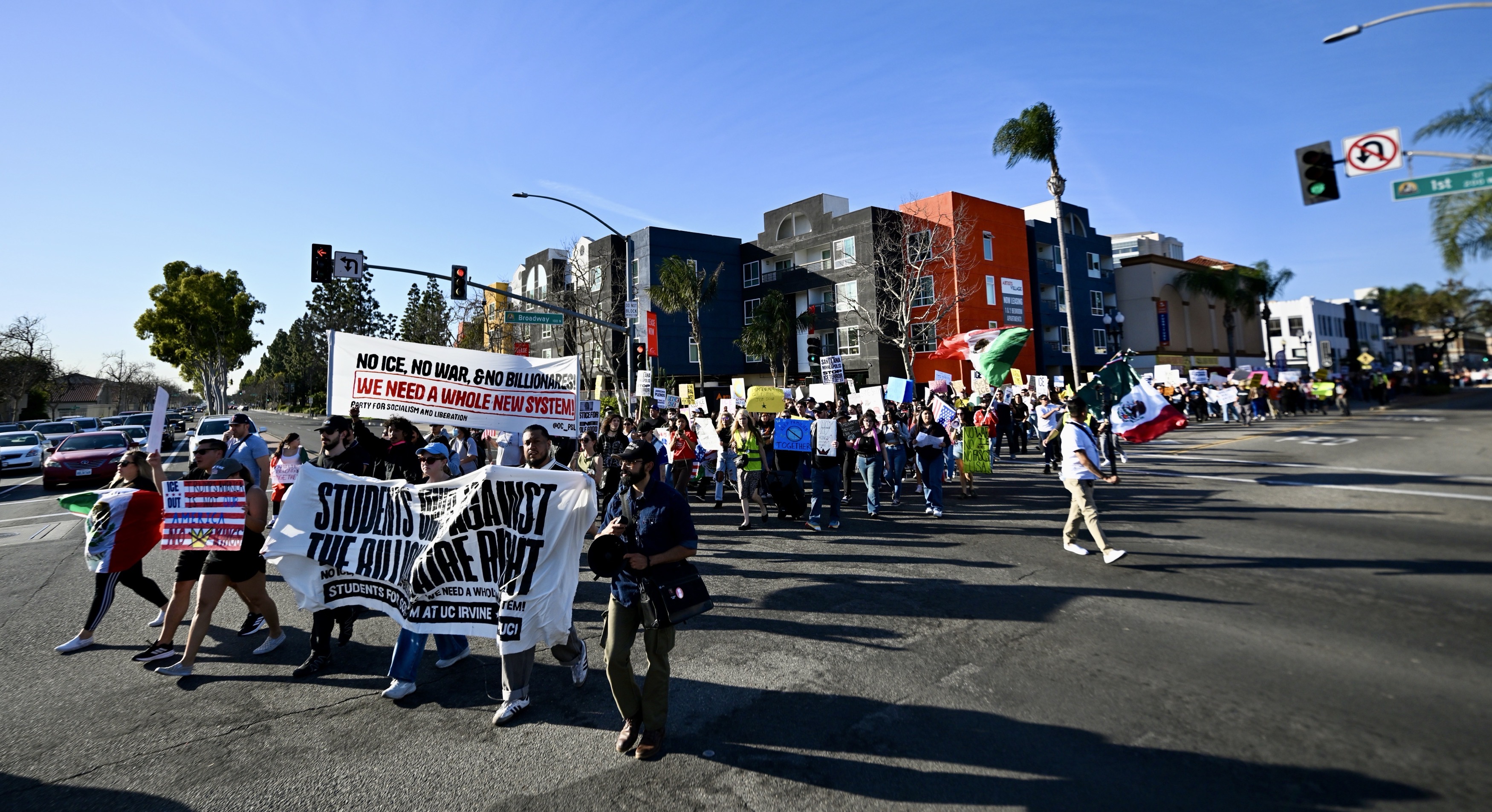 Protesters march through the intersection of Broadway and First Street...