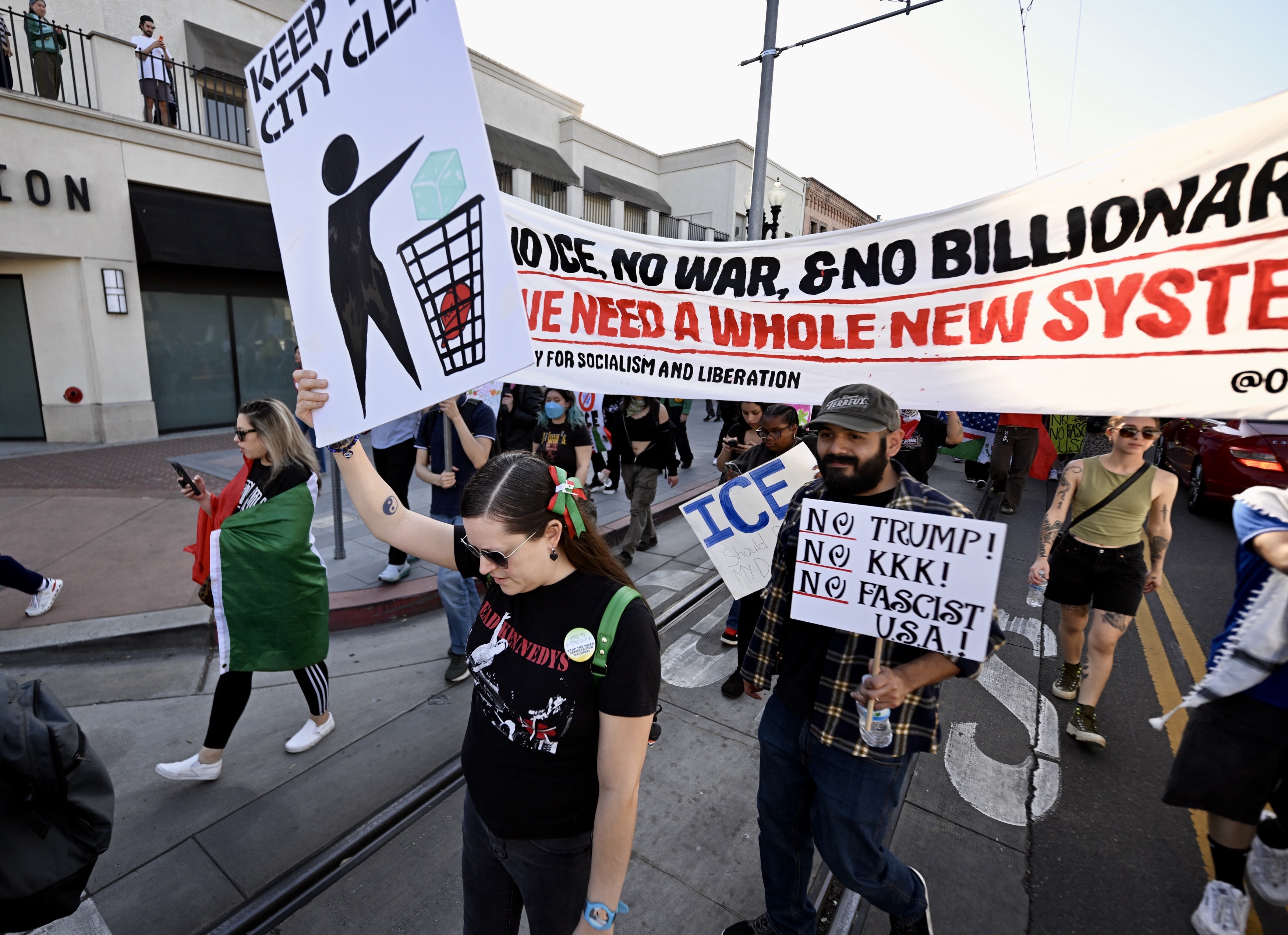 Protesters march on Fourth Street during a demonstration against ICE...
