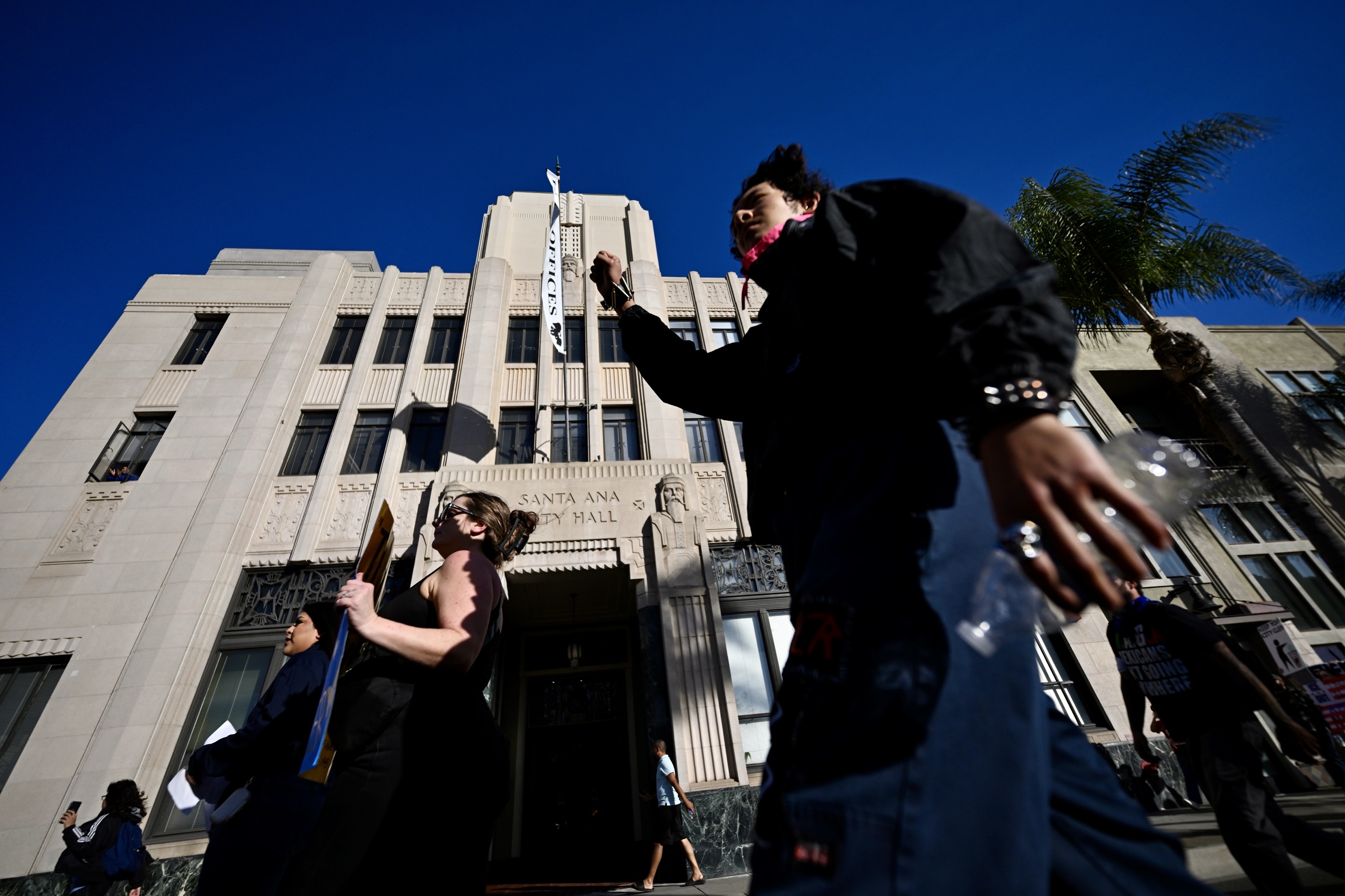 Protesters march on Main Street during a demonstration against ICE...