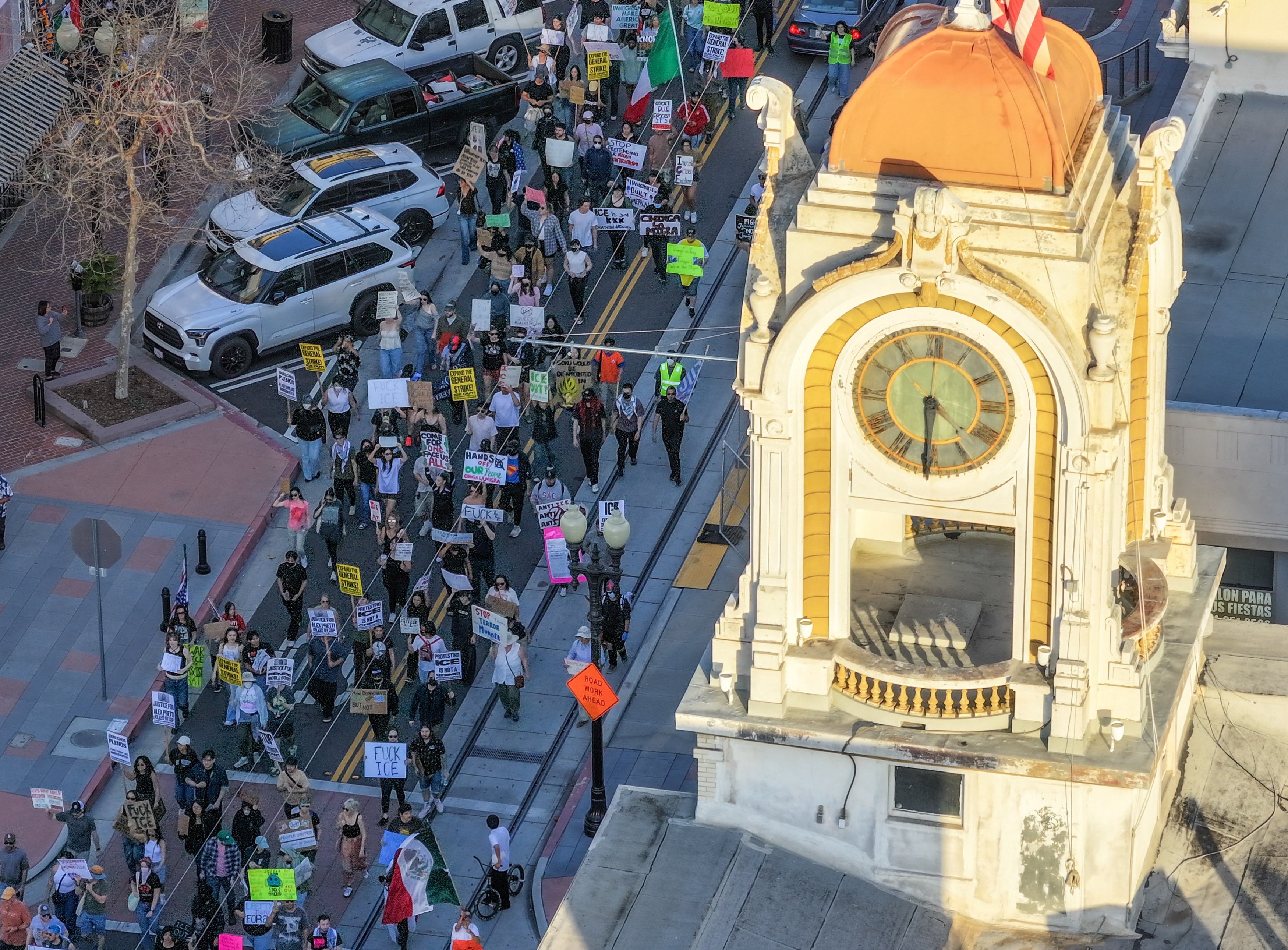 Protesters march on Fourth Street during a demonstration against ICE...
