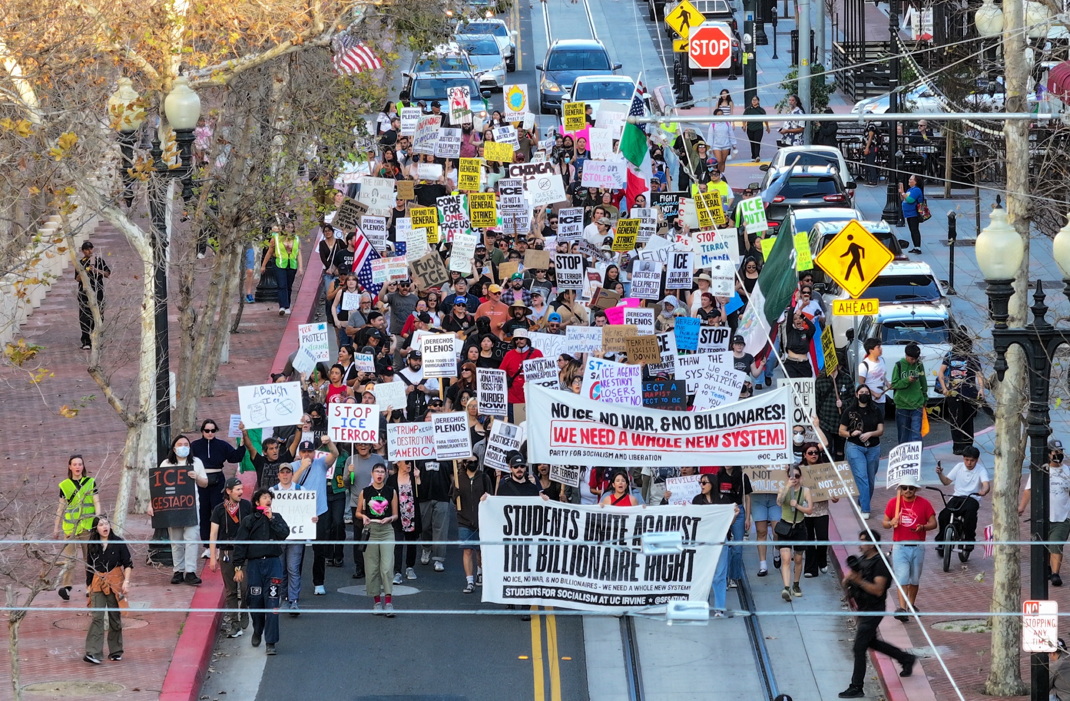 Protesters march on Fourth Street during a demonstration against ICE...