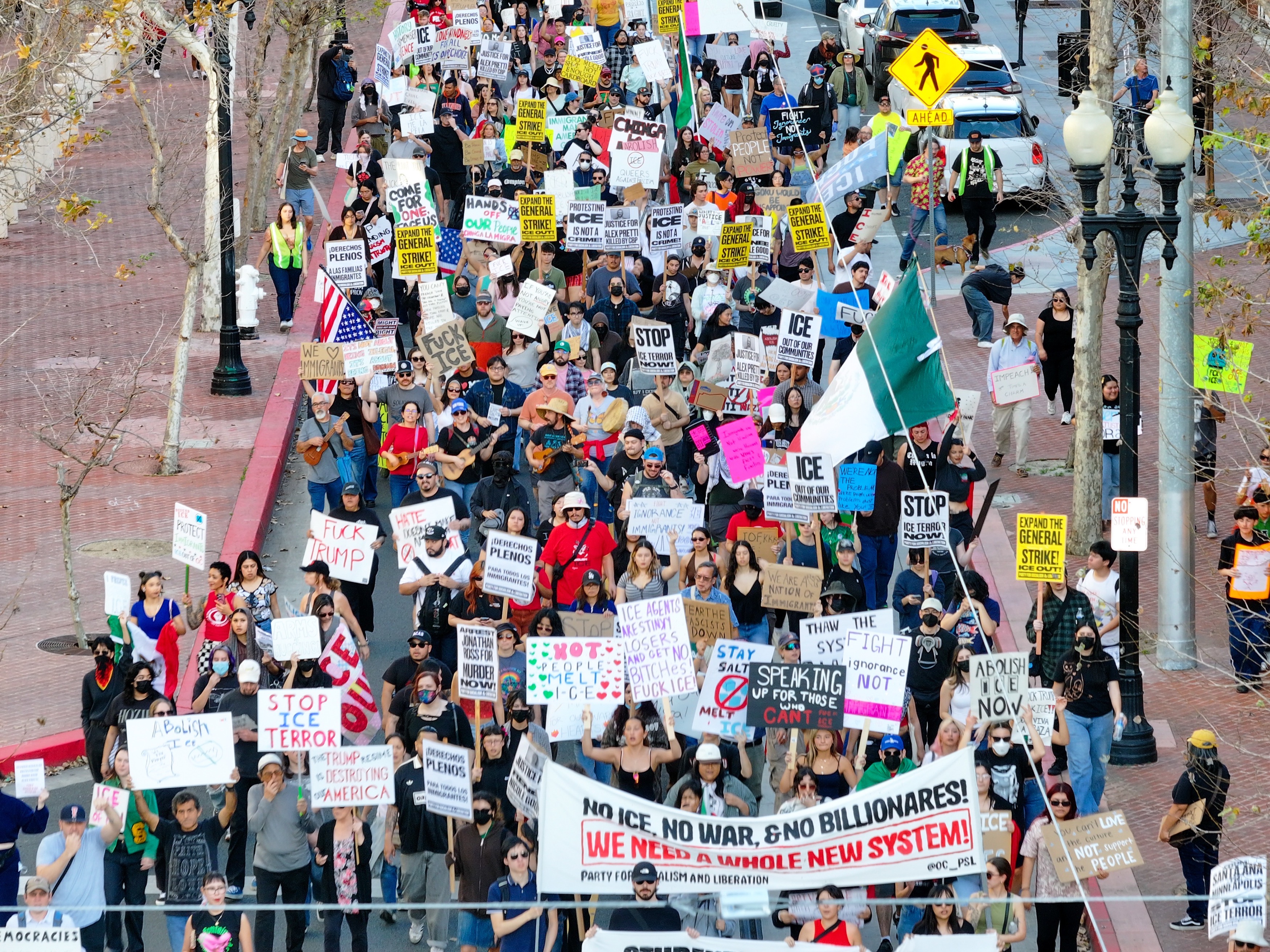 Protesters march on Fourth Street during a demonstration against ICE...