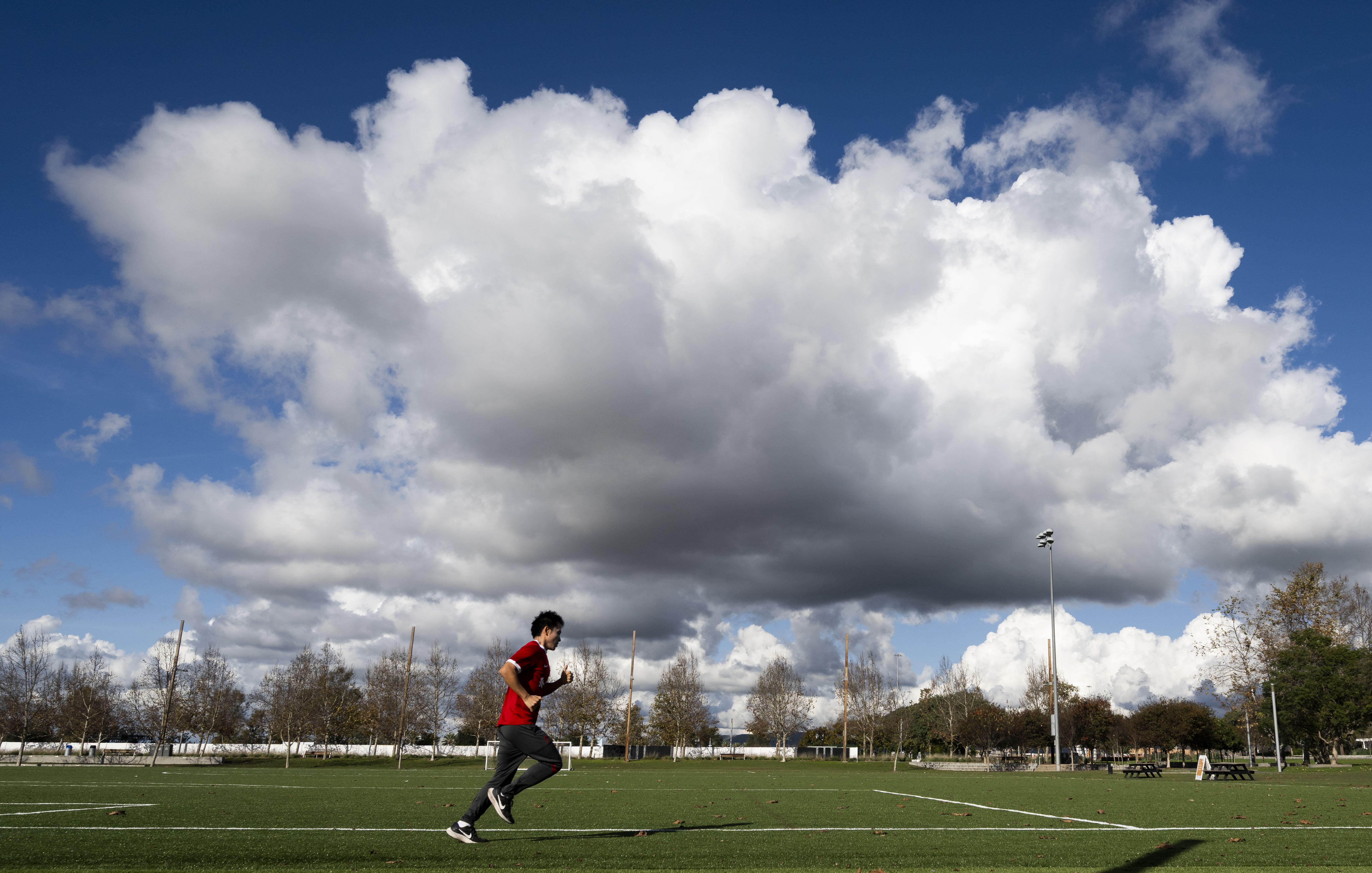 A man runs around the soccer fields at the Great...
