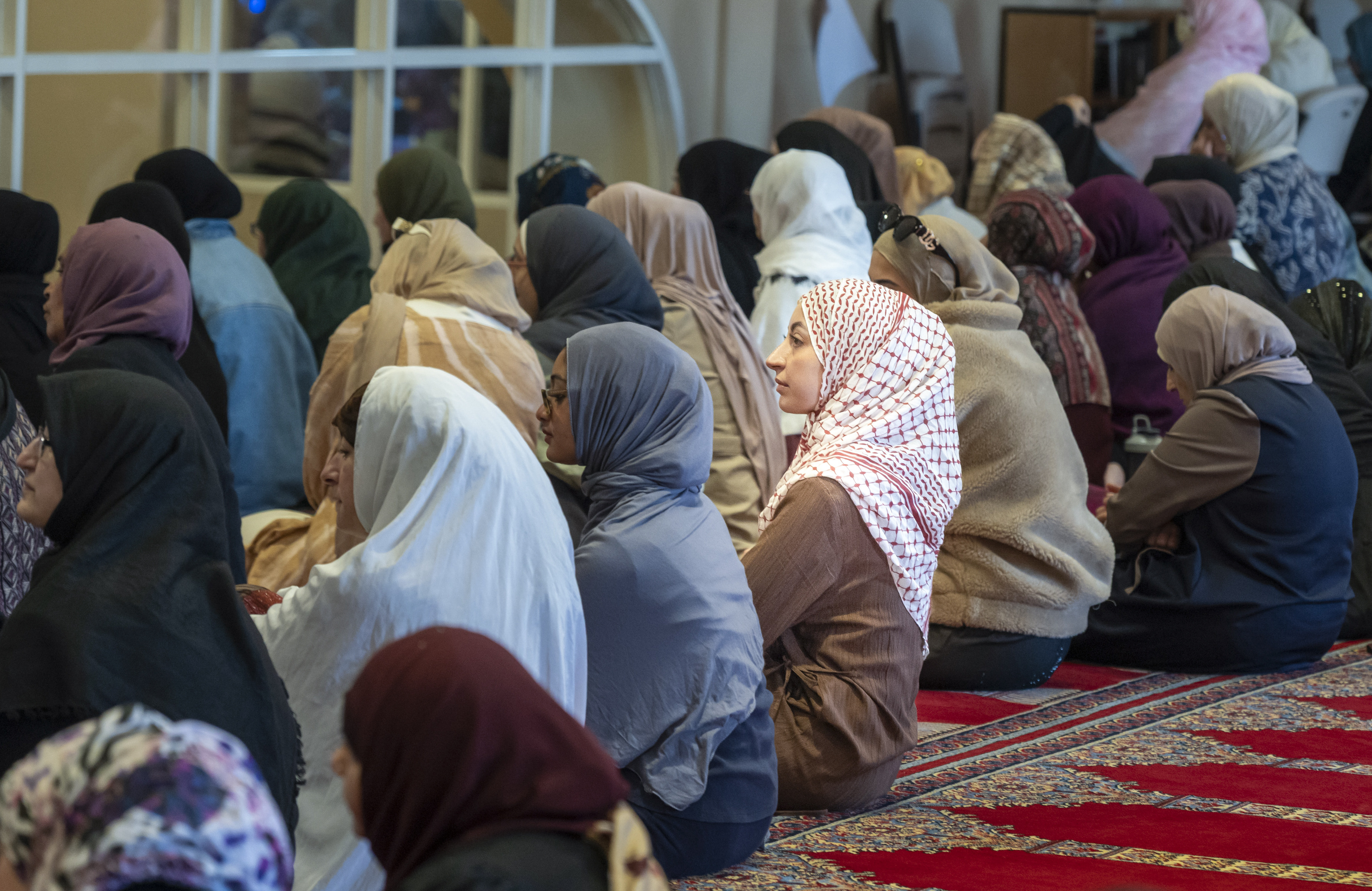 Women gather for the prayer service at the Islamic Society...