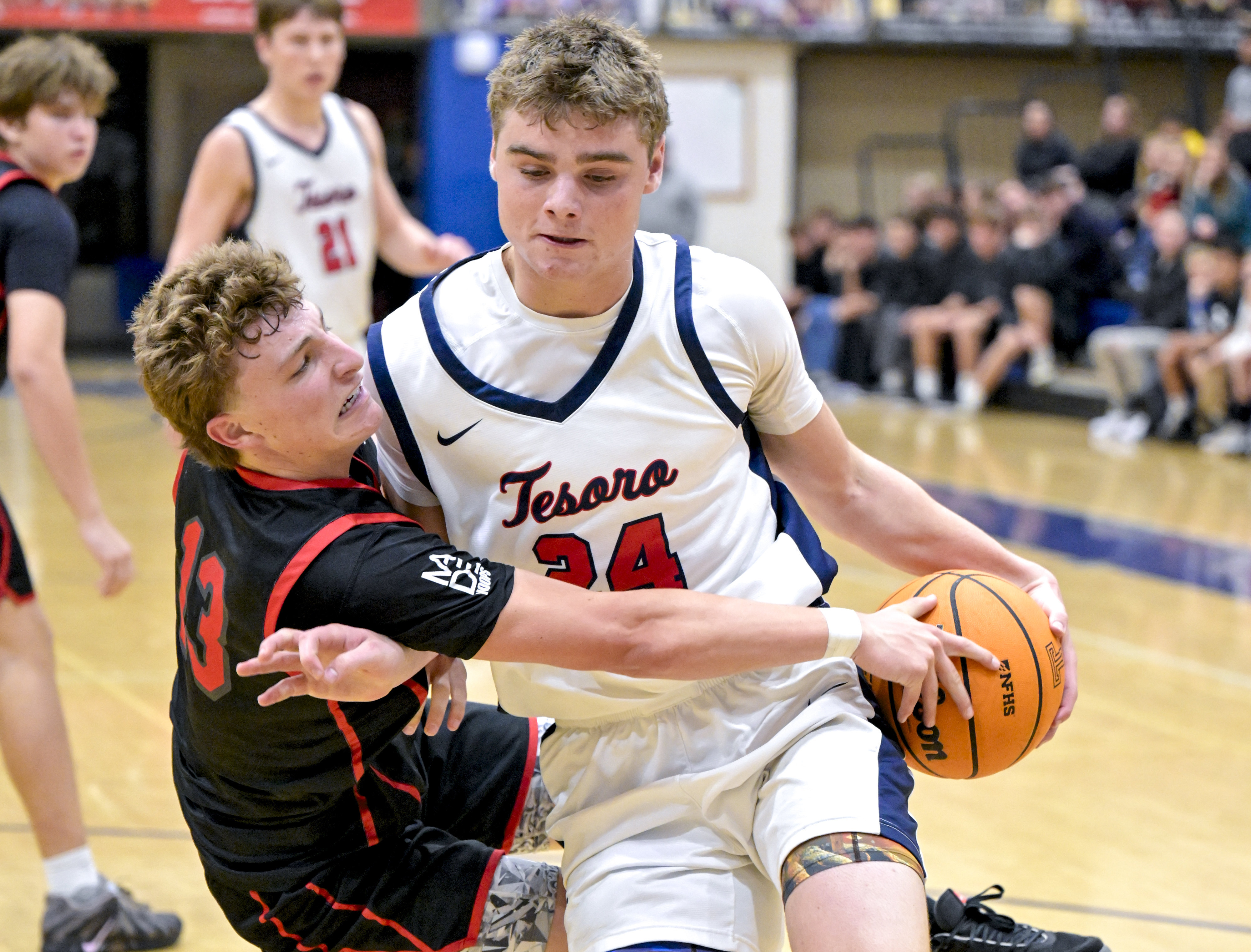 Tyson Christensen (13) of San Clemente fouls Owen Hatch (24)...