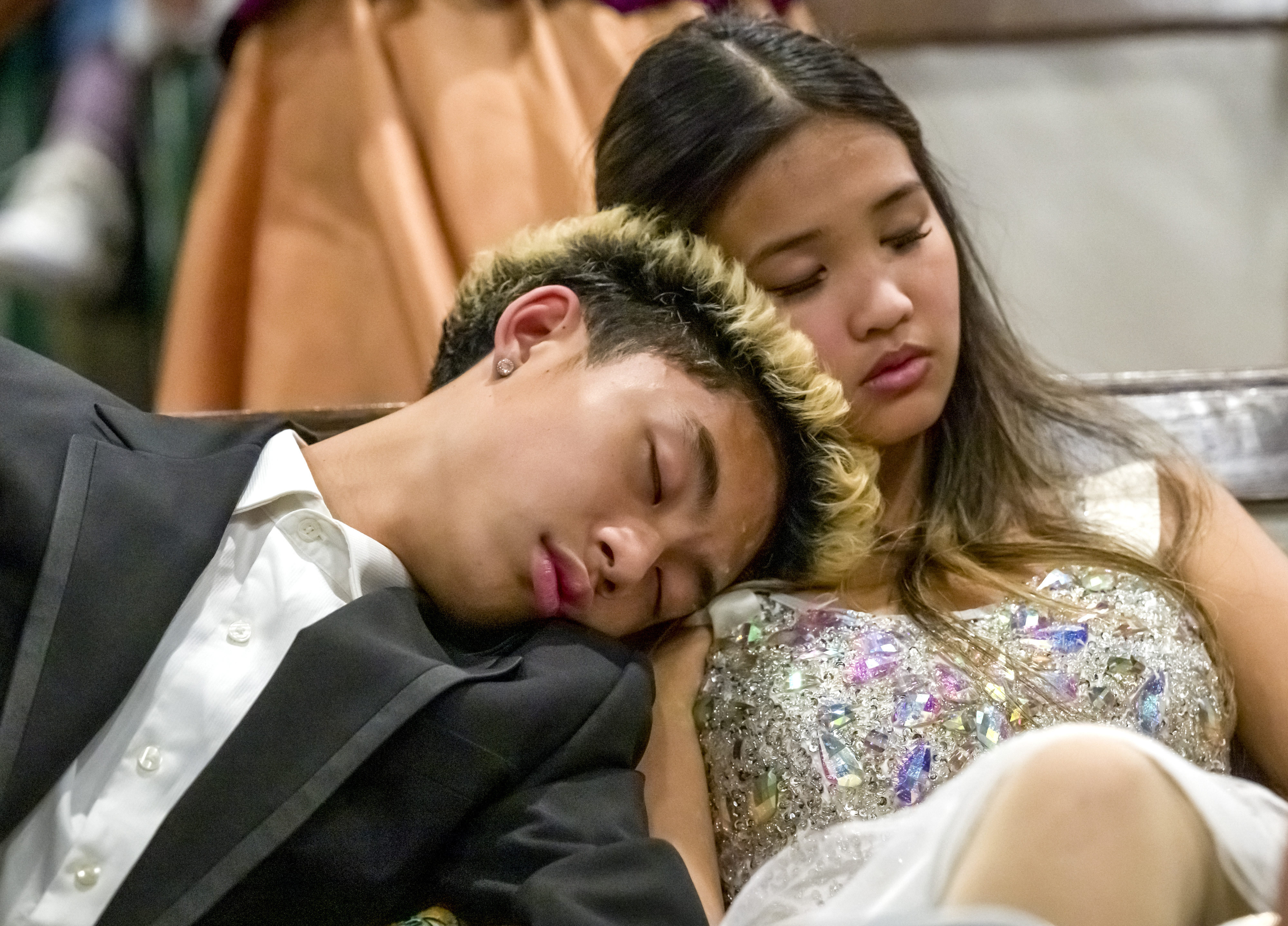 Exhausted after hours of rehearsing, Dylan Untal, 17, left, Emily...