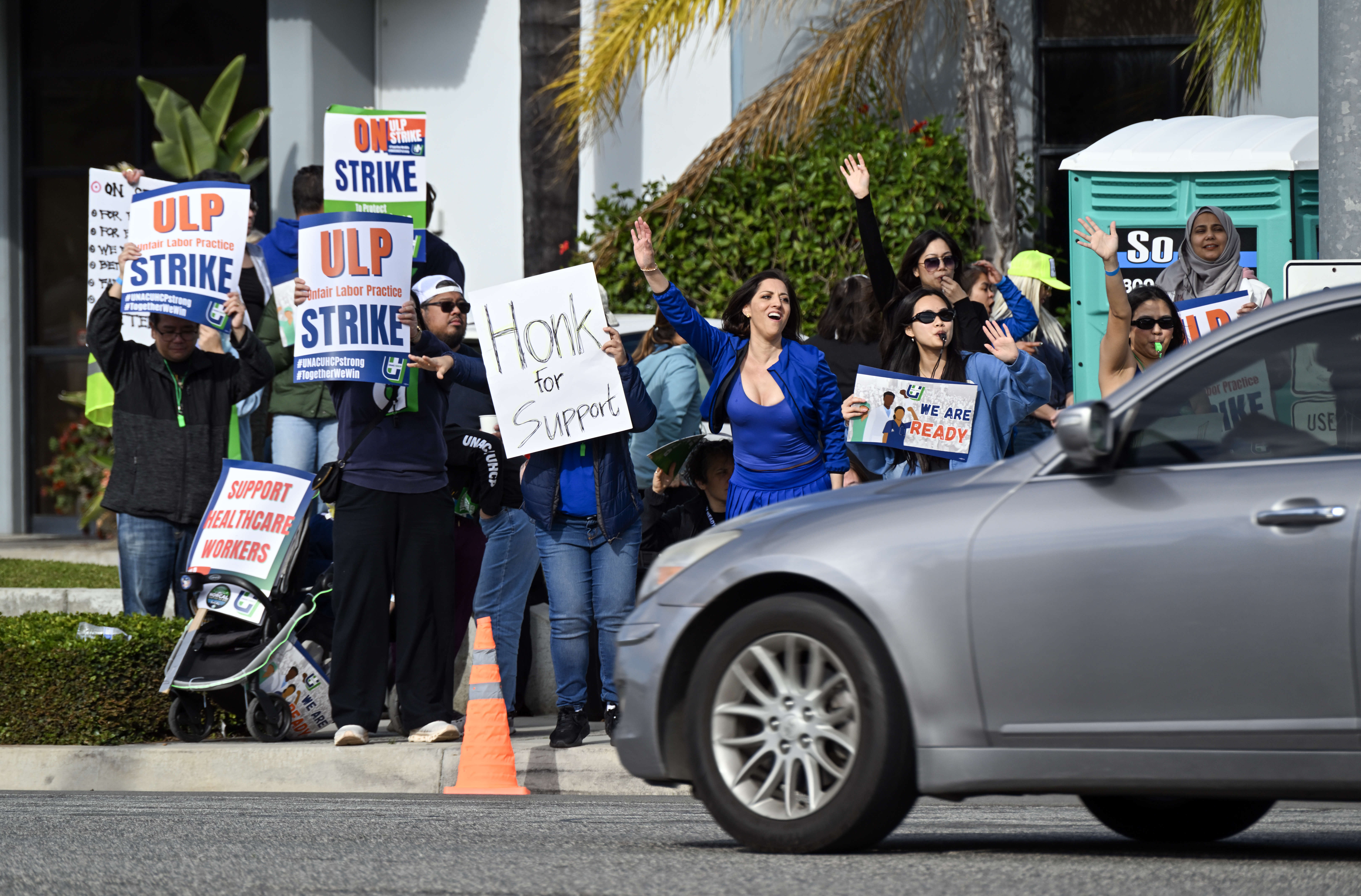 Nurse Delia Lopez, center, joins fellow health care workers as...