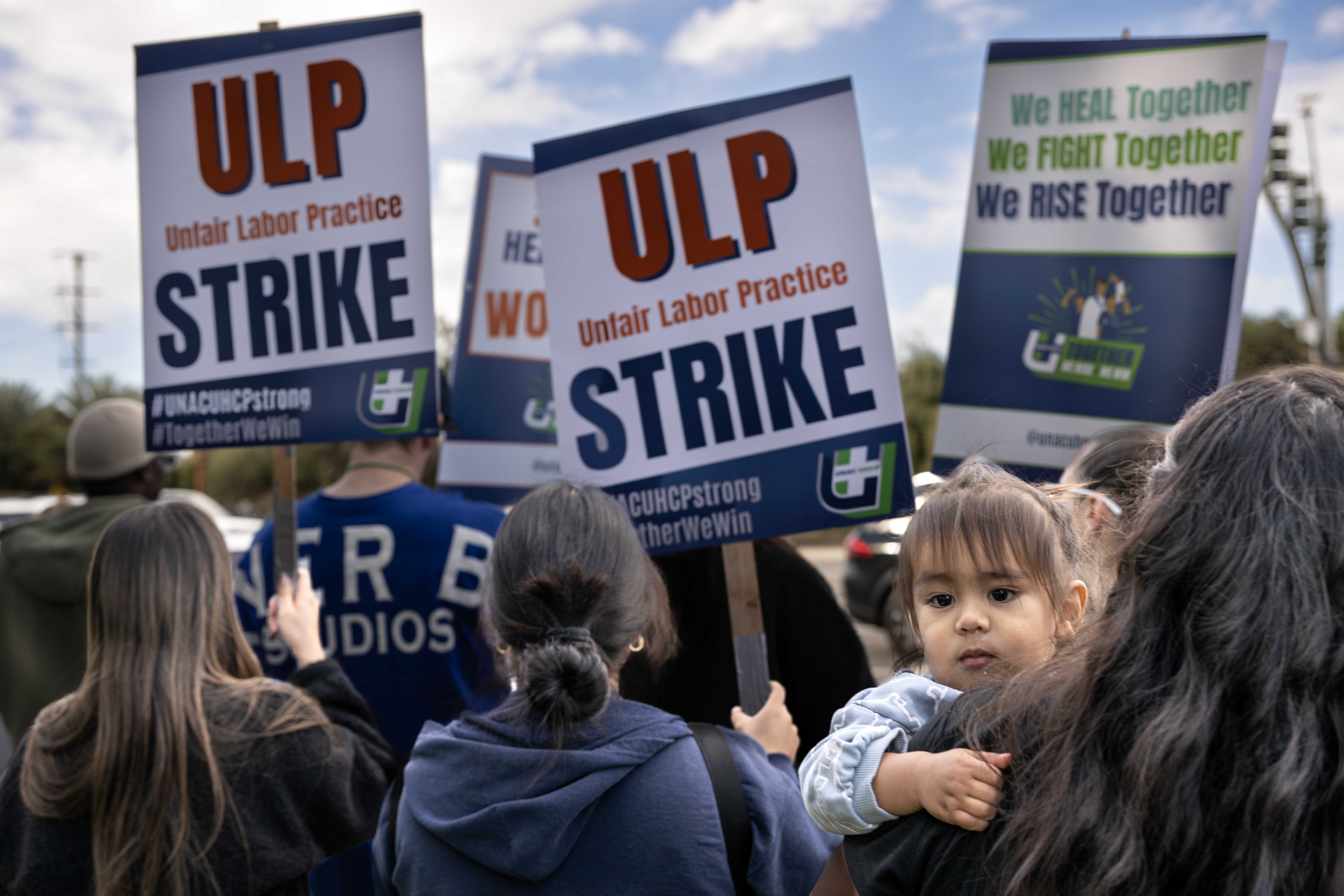 Nurse Raquel Tinoco holds her 2-year-old son, Frankie, as she...