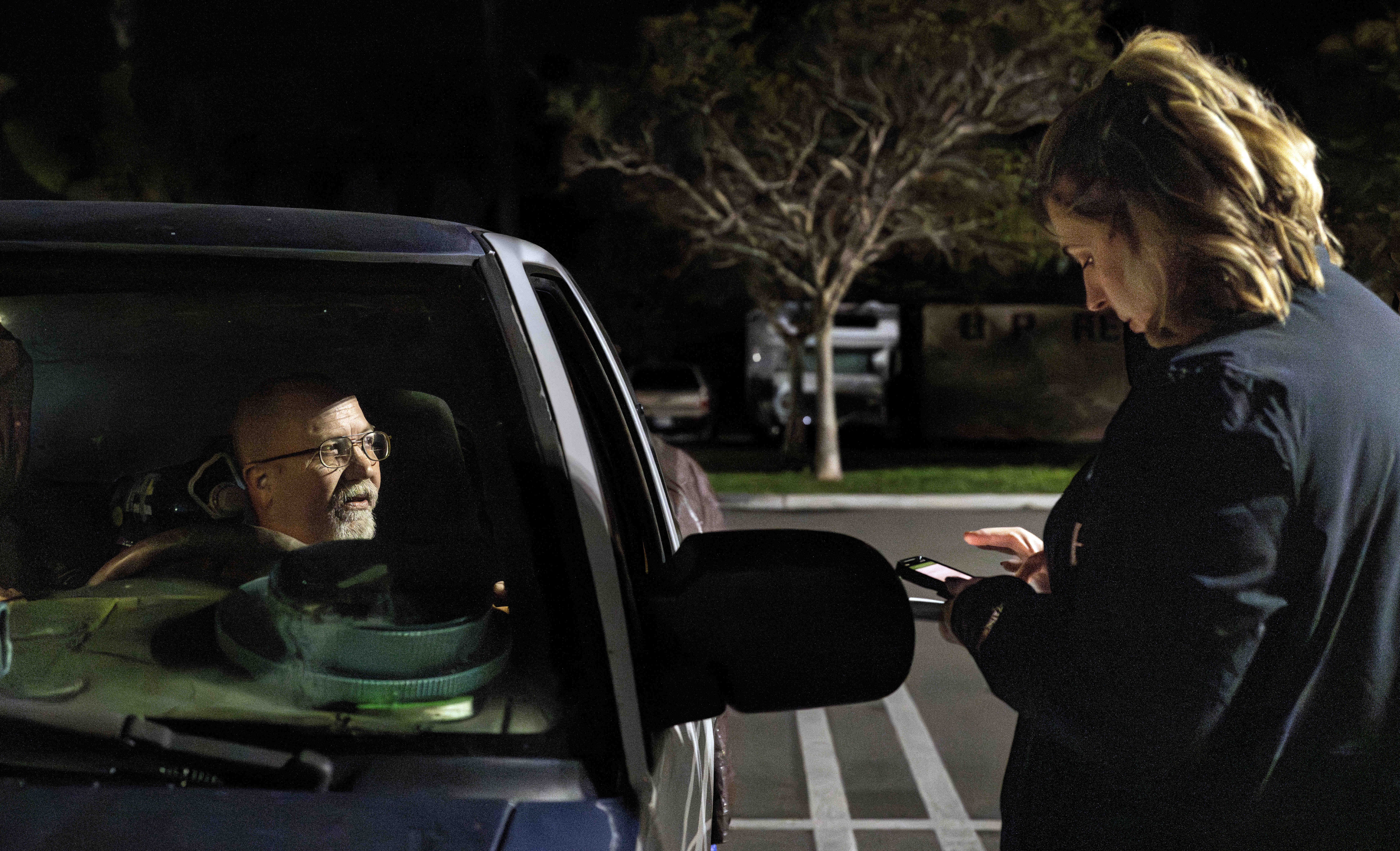 Huntington Beach Homeless Services Manager Jessica Kelly talks to Darin,...