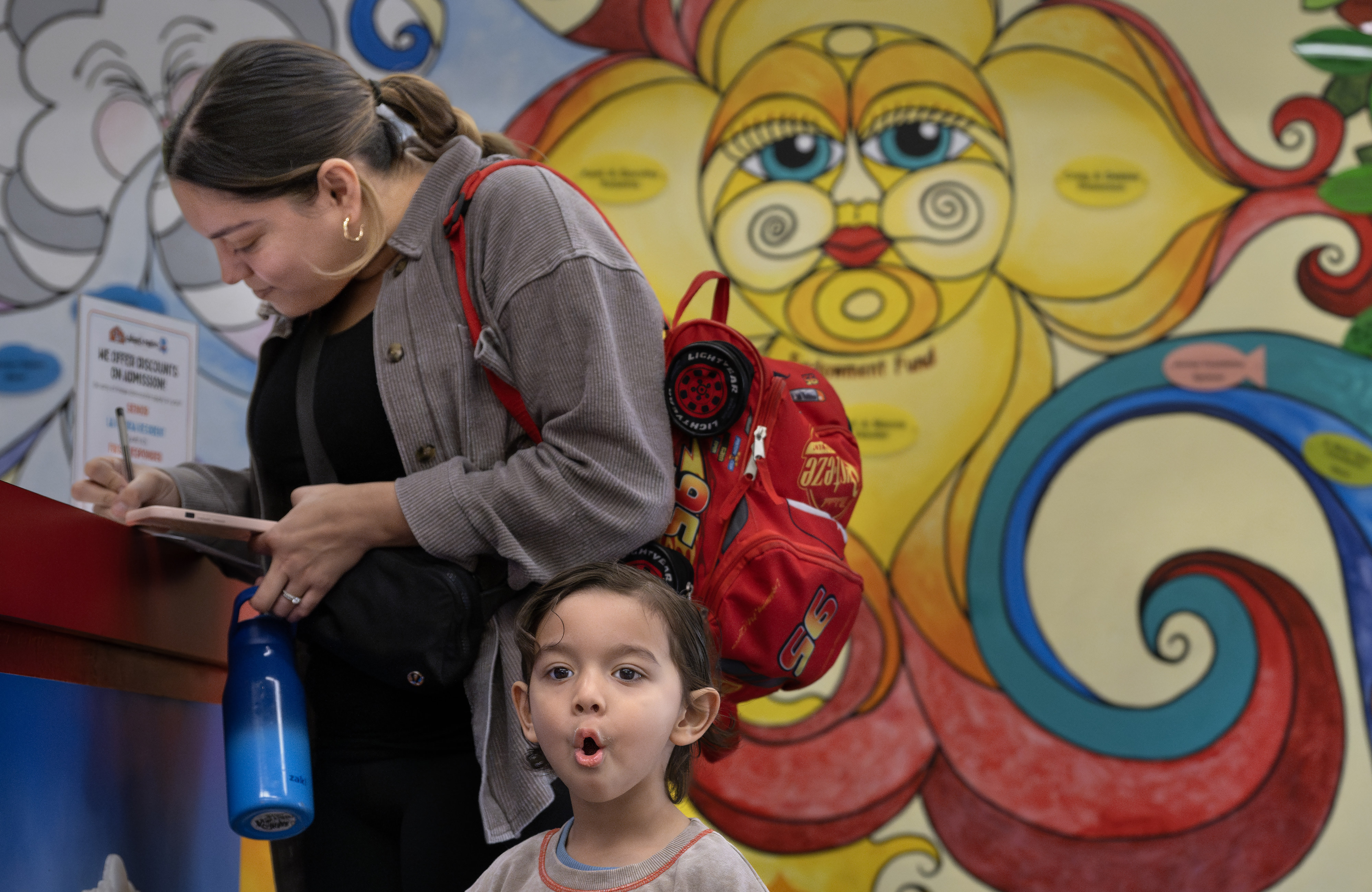 Jessica Garcia signs in at the Children’s Museum of La...