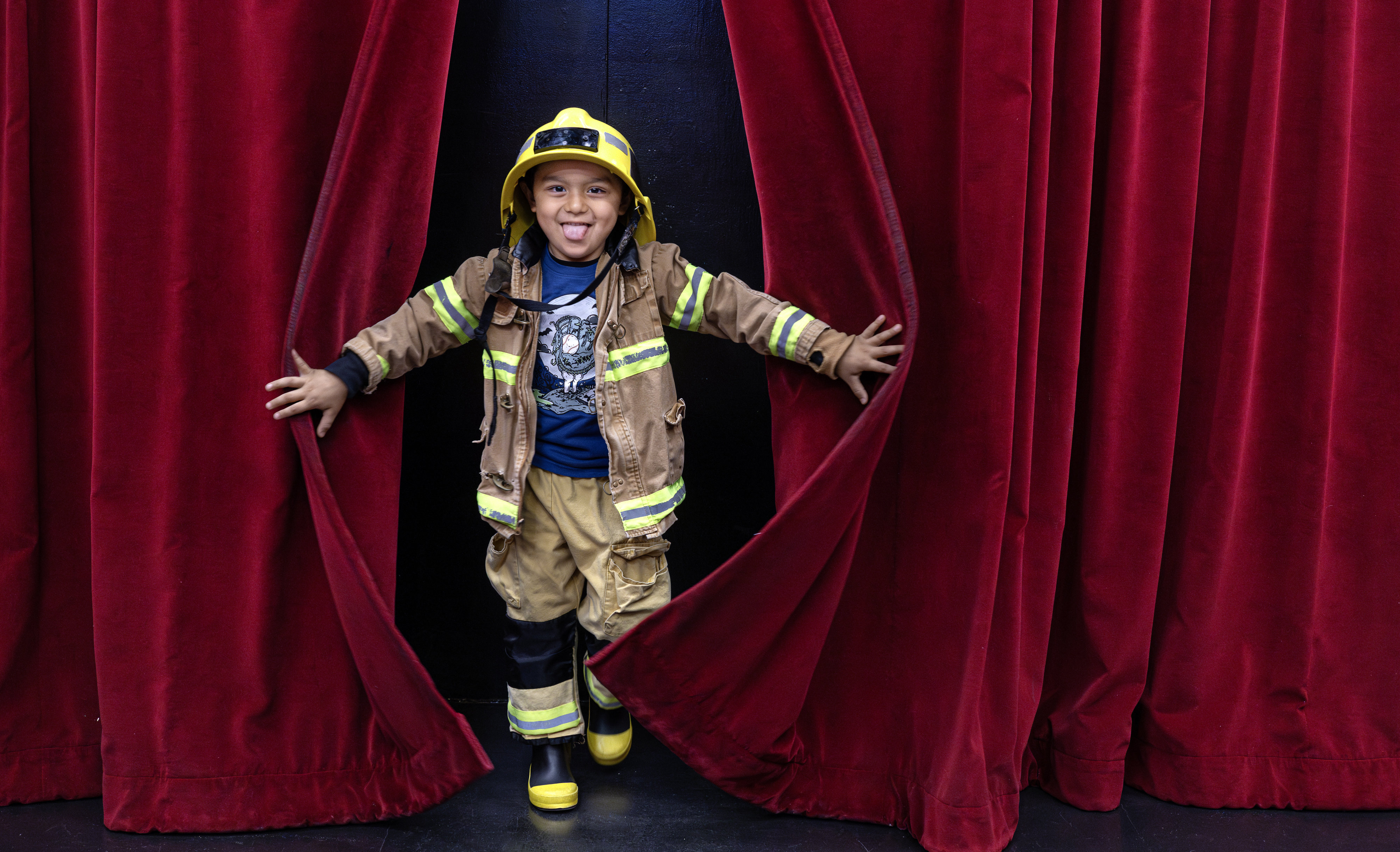 Ollin Gasca, 4, pops out from behind the curtains inside...