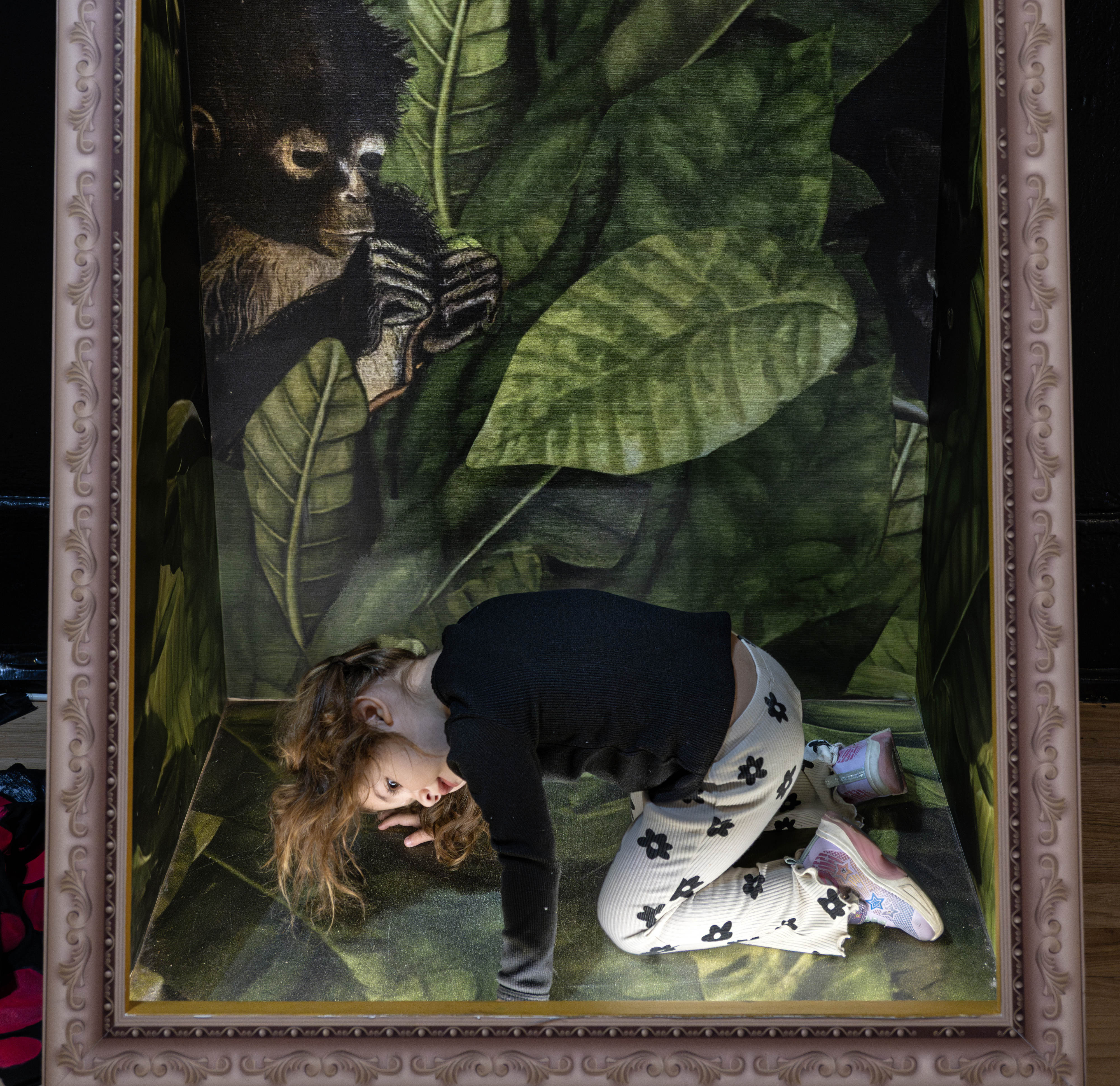 Layne Ortega, 2, strikes a pose inside a framed piece...