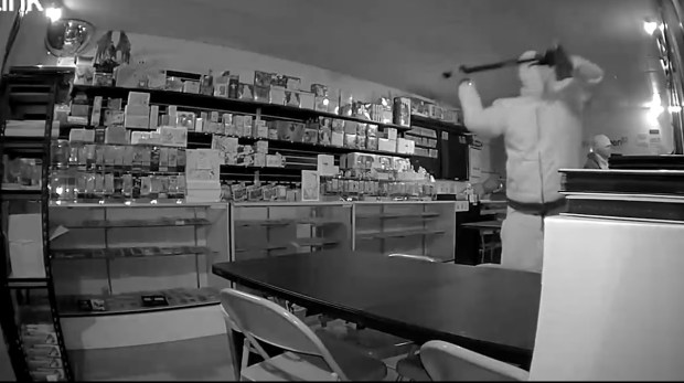 A security camera captured a suspect using a sledgehammer to shatter display cases inside Do-We Collectibles early Wednesday morning. (Courtesy of Do-We Collectibles)