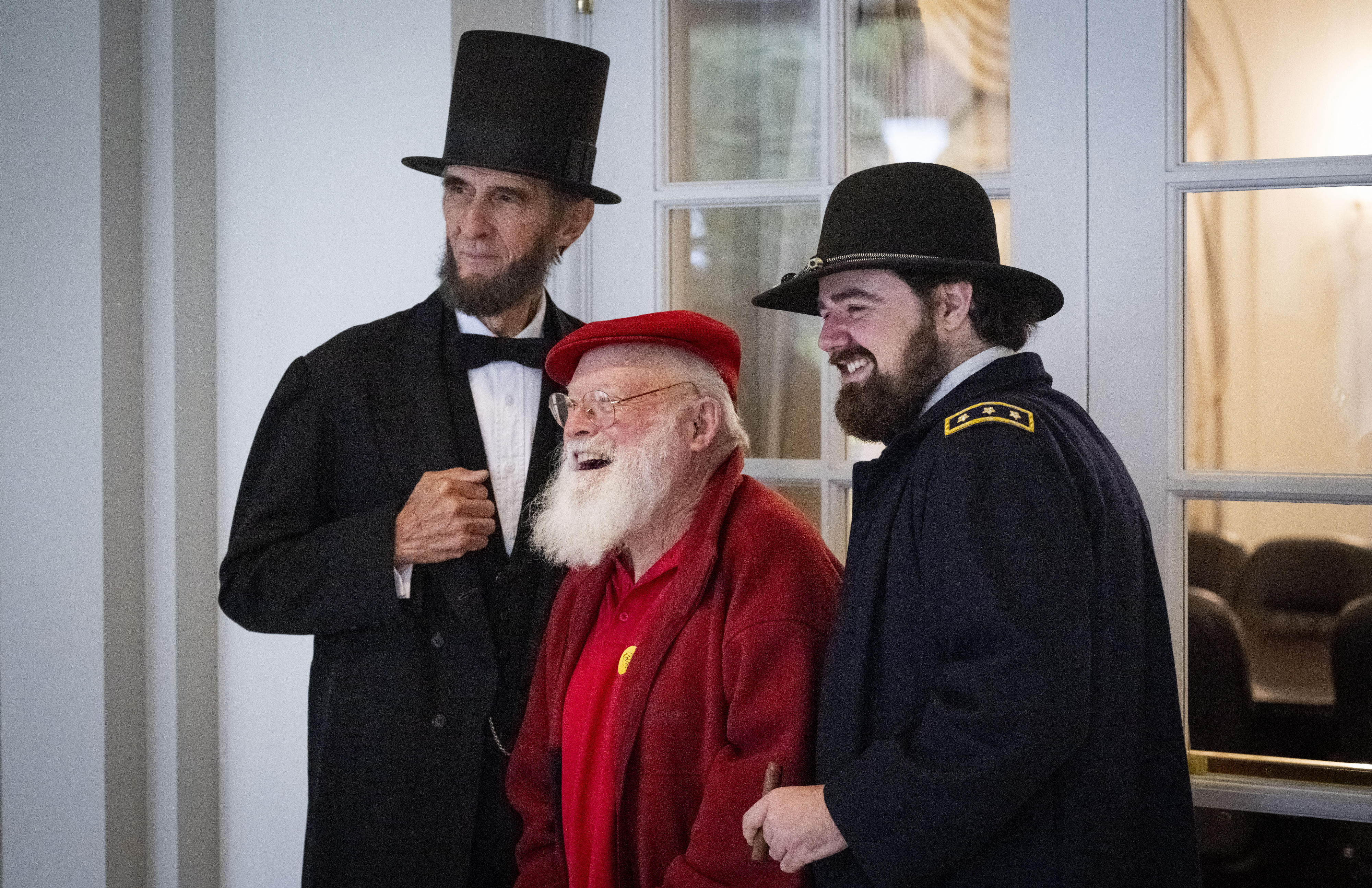 Jim Ponnet, 74, takes a photo with Abraham Lincoln and...
