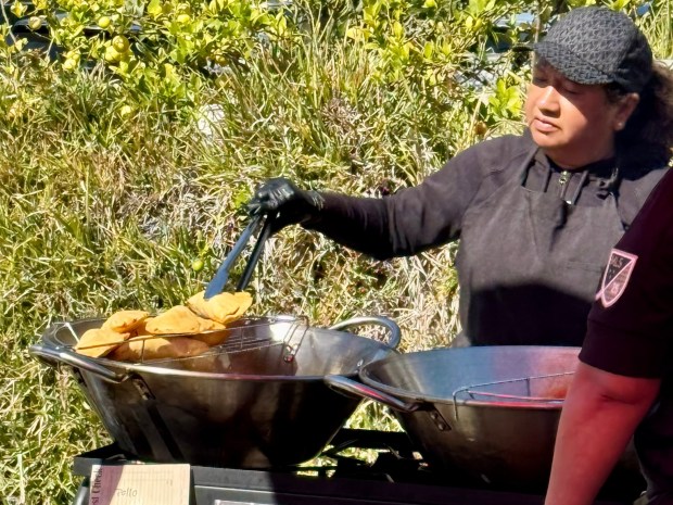 A colleague fries the quesadillas, which are made fresh to order. (Photo by Brock Keeling, Orange County Register/SCNG)