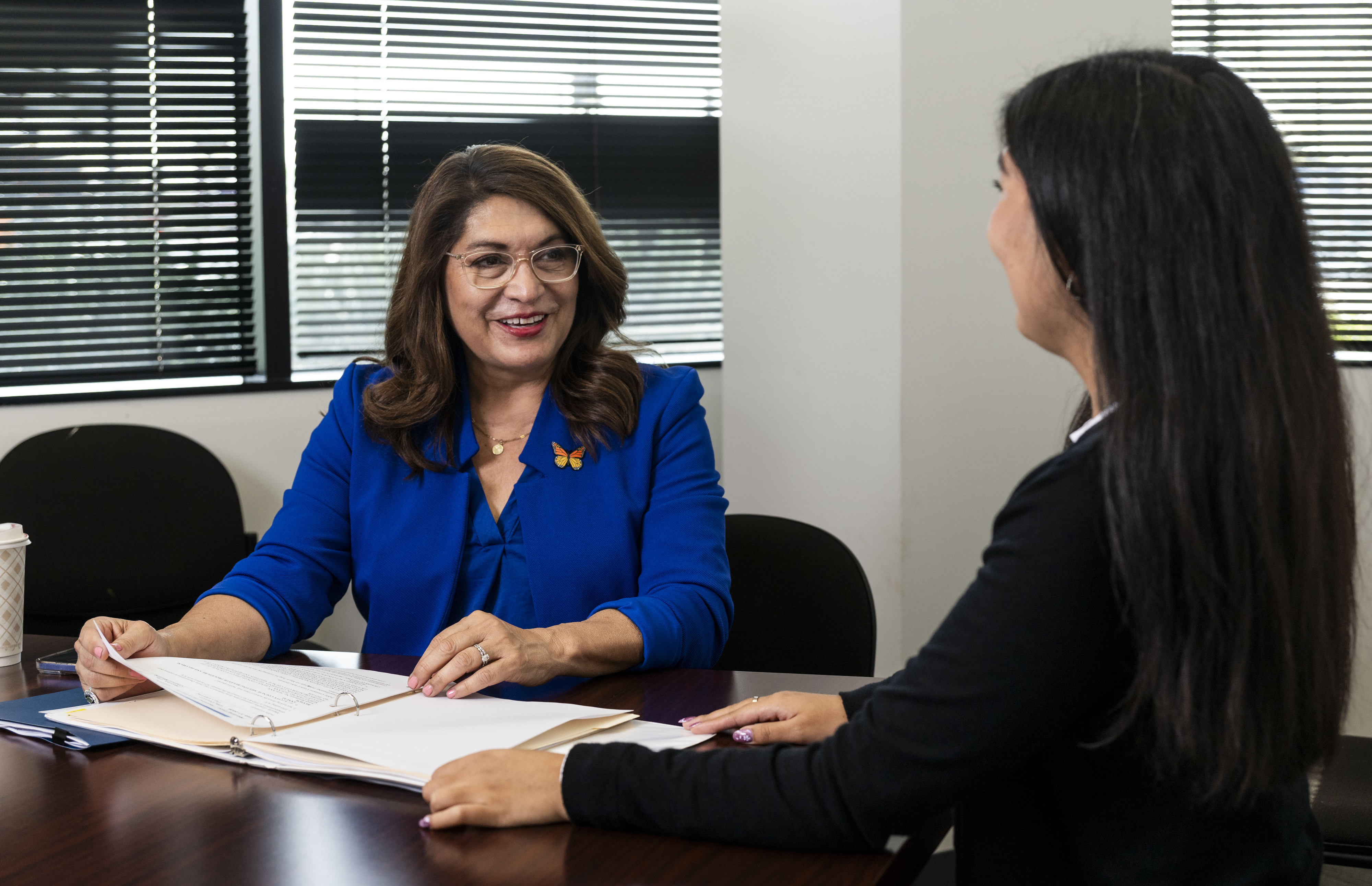 California Assemblymember Sharon Quirk-Silva talks with Field Representative Isabella Carbajal...