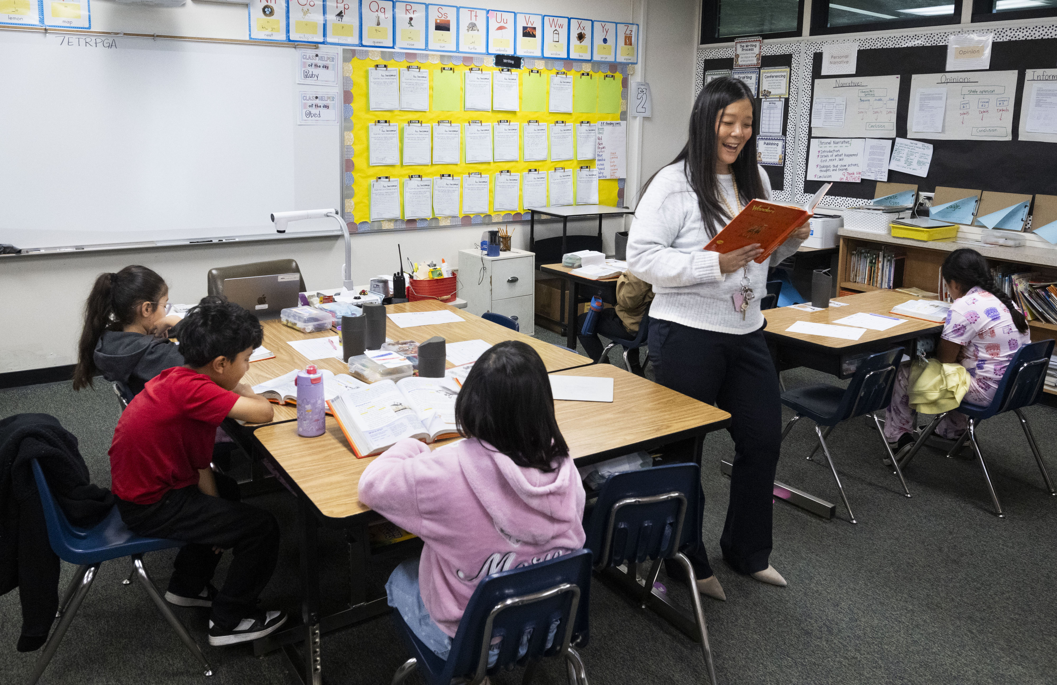 Third-grade teacher Linda Kim works with students at Rosita Elementary...