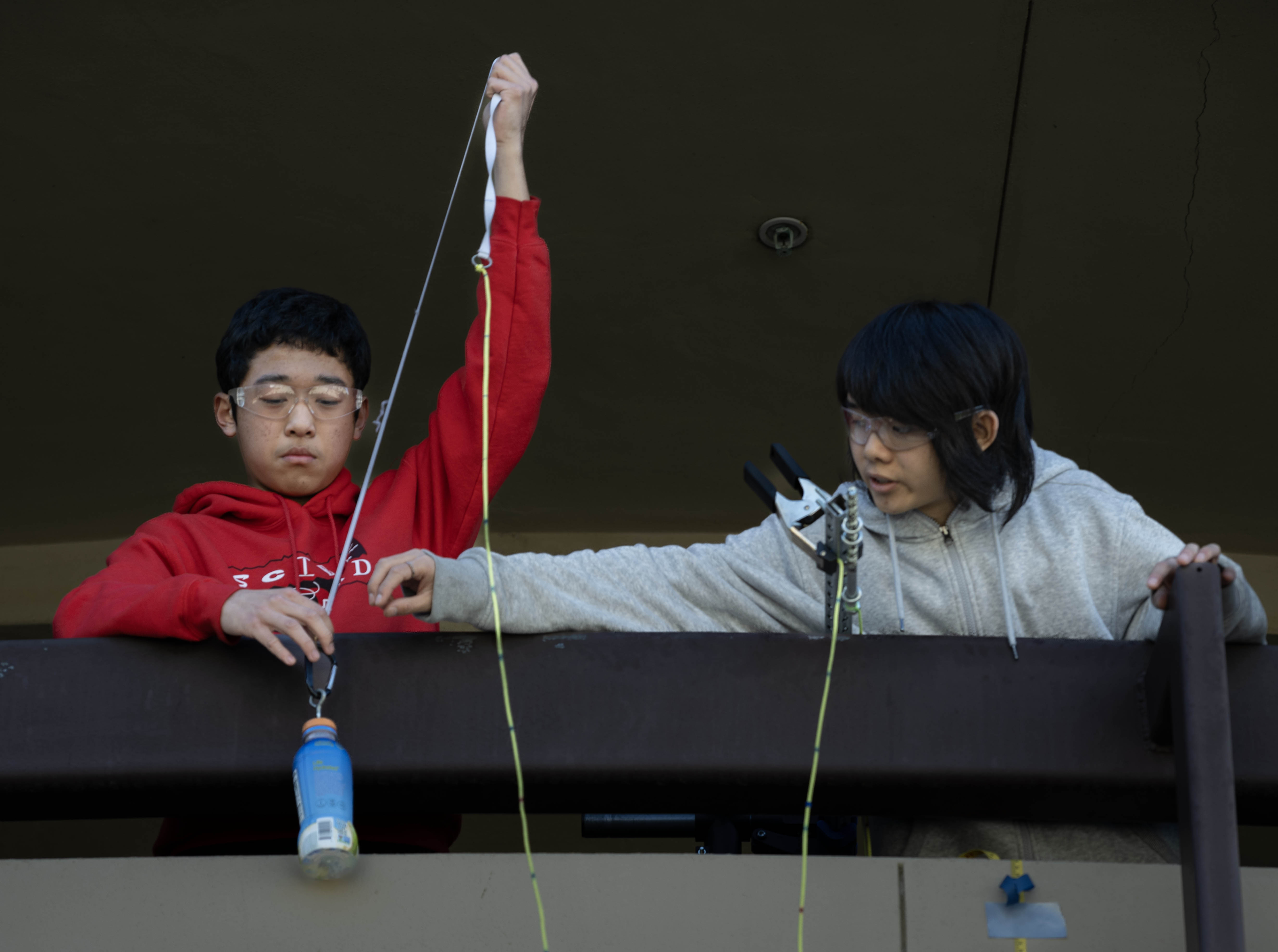 Troy High School students Lucas Chen, 15, left, and teammate...