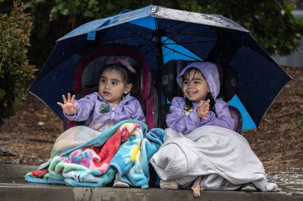 Sisters Ximena Aguillar, 2, left, and Mariah, 3, keep warm and dry during the 64th annual Swallows Day Parade in San Juan Capistrano on Saturday, March 23, 2024. (Photo by Mindy Schauer, Orange County Register/SCNG)