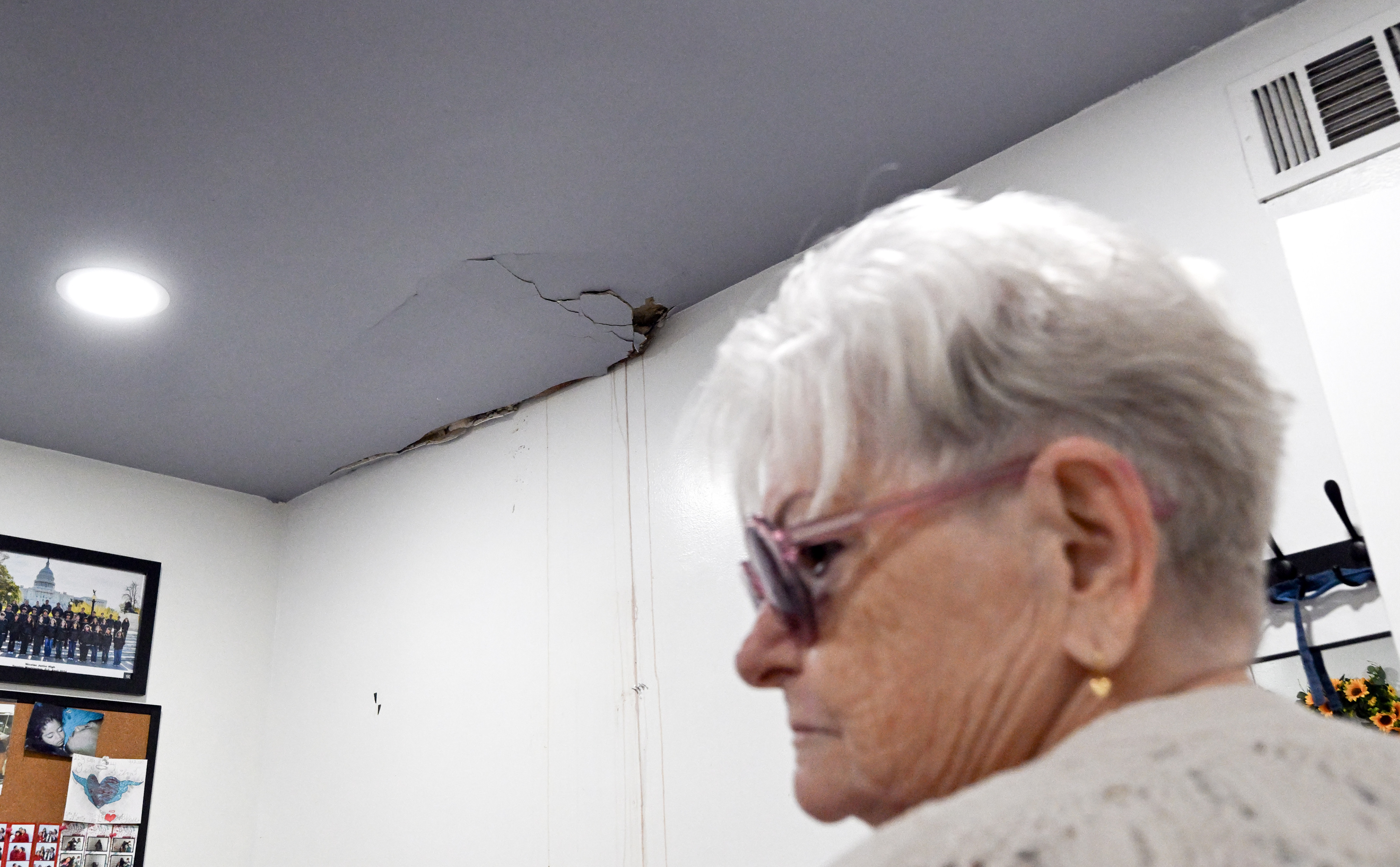 Vicky Aguilar surveys damage inside a bedroom from a tree...
