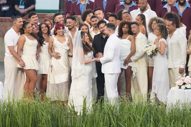Elly Aparicio and Thomas "Tommy" Wolter dressed as a bride and groom as the participate in the Bad Bunny performance during halftime of the NFL Super Bowl 60 football game between the Seattle Seahawks and the New England Patriots, Feb. 8, 2026, in Santa Clara, Calif. (Frank Franklin II/AP)