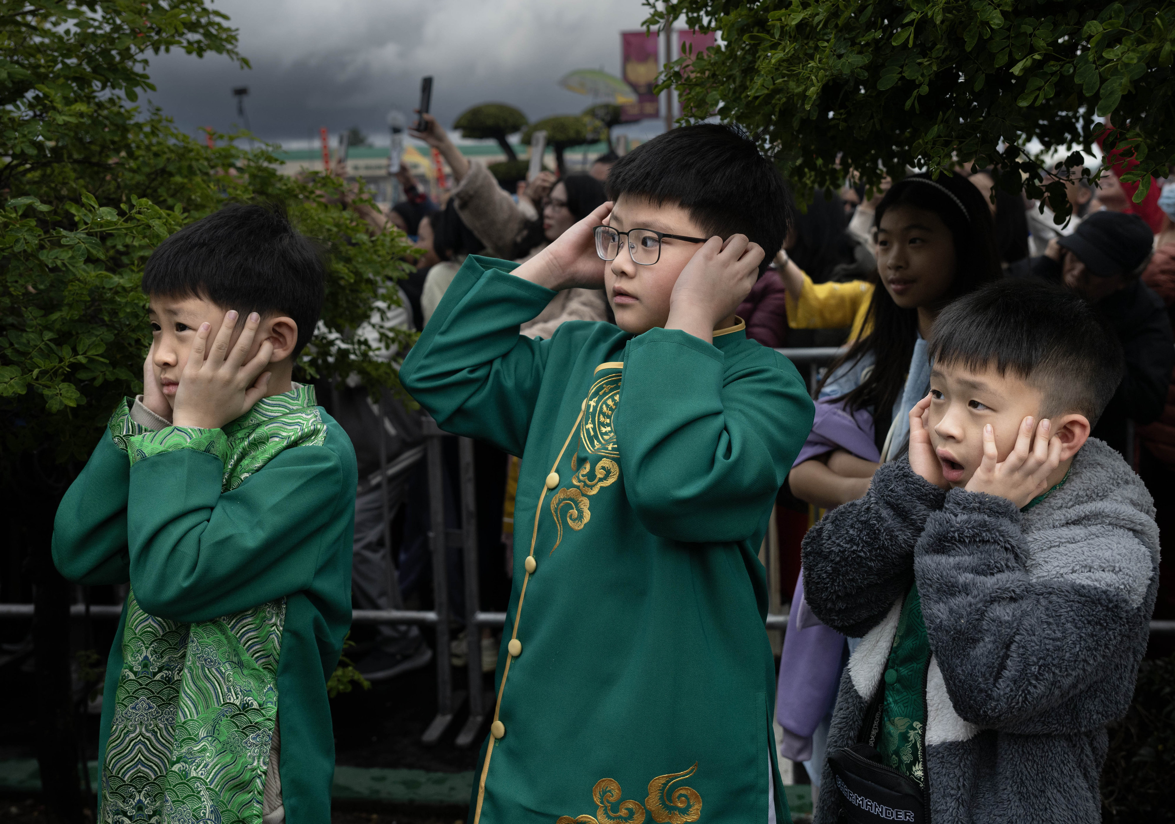 Boys cover their ears during Asian Garden Mallâs 2026 Lunar...