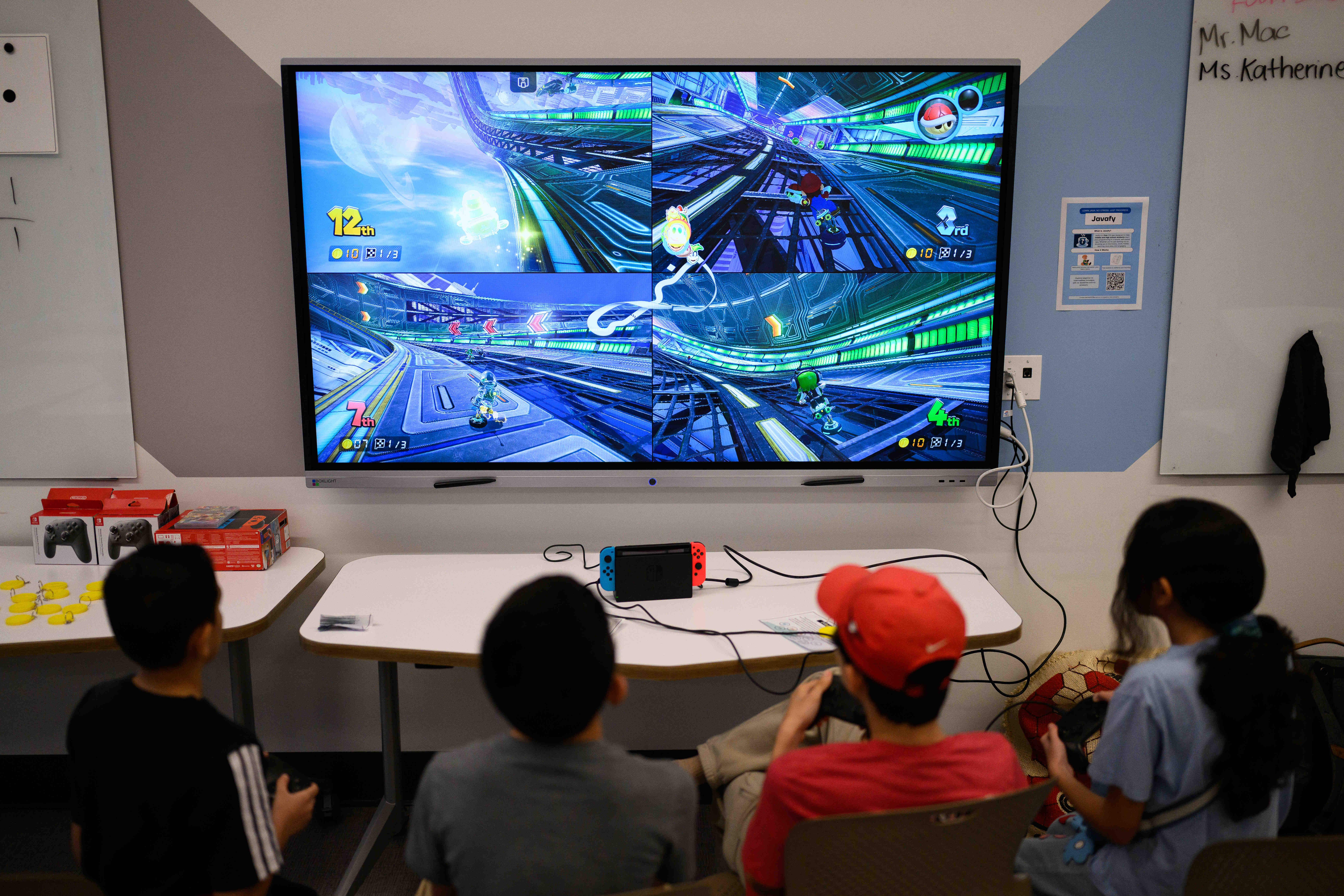 Students play the video game Mario Kart during an event...