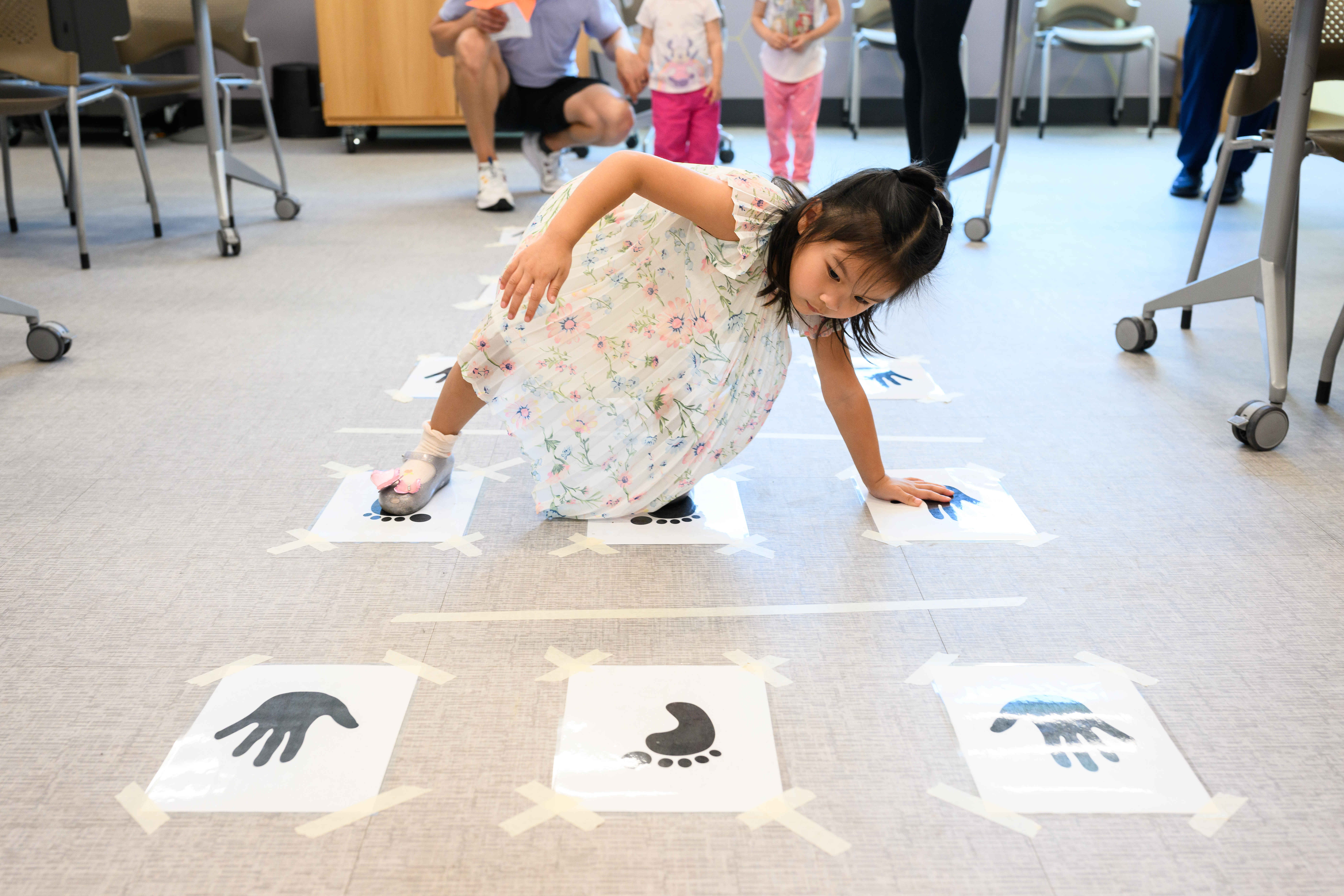 Chloe Giang, 3, tests her coordination in a game of...