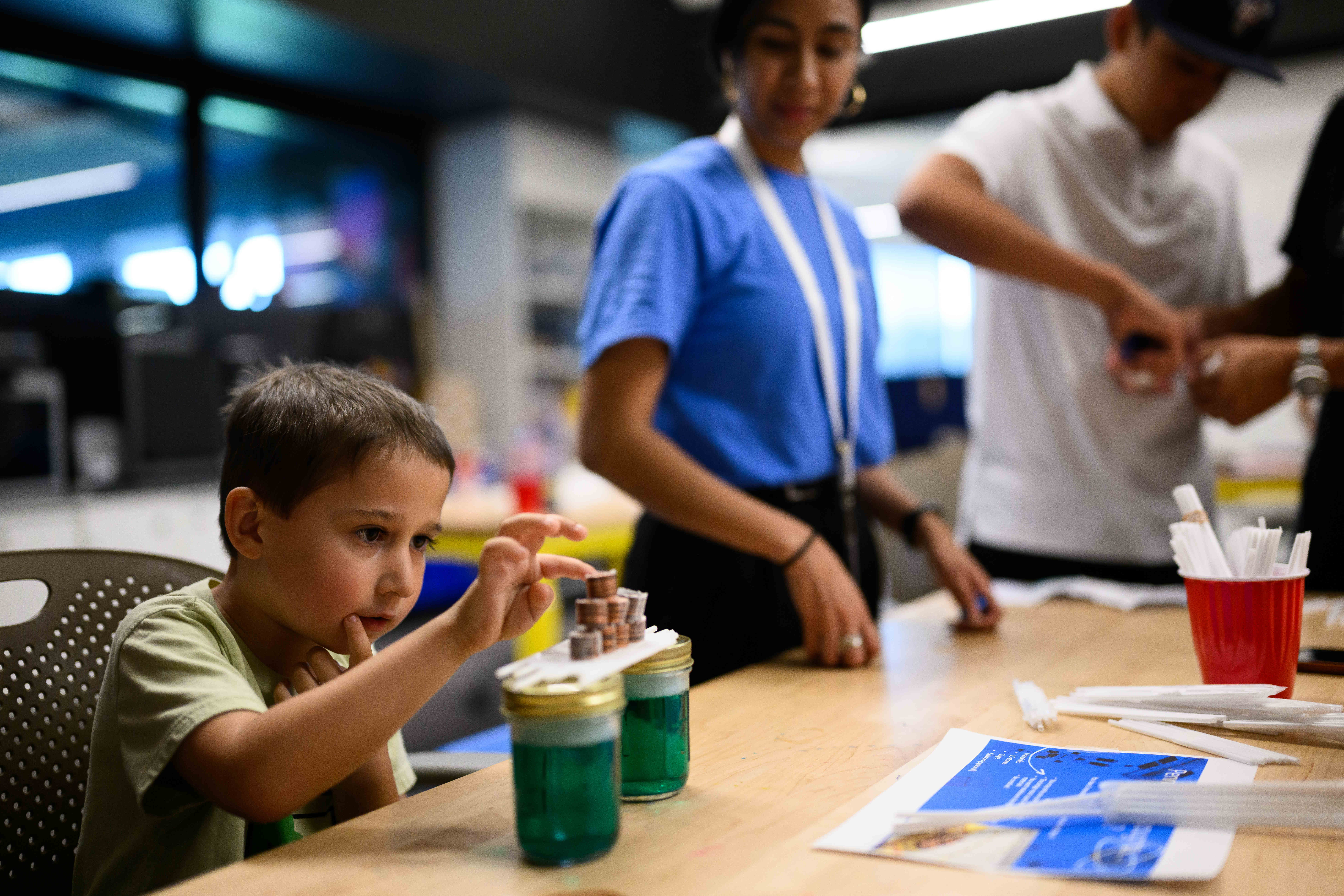 Theodore Pattison, 5, tests his straw bridge during an event...