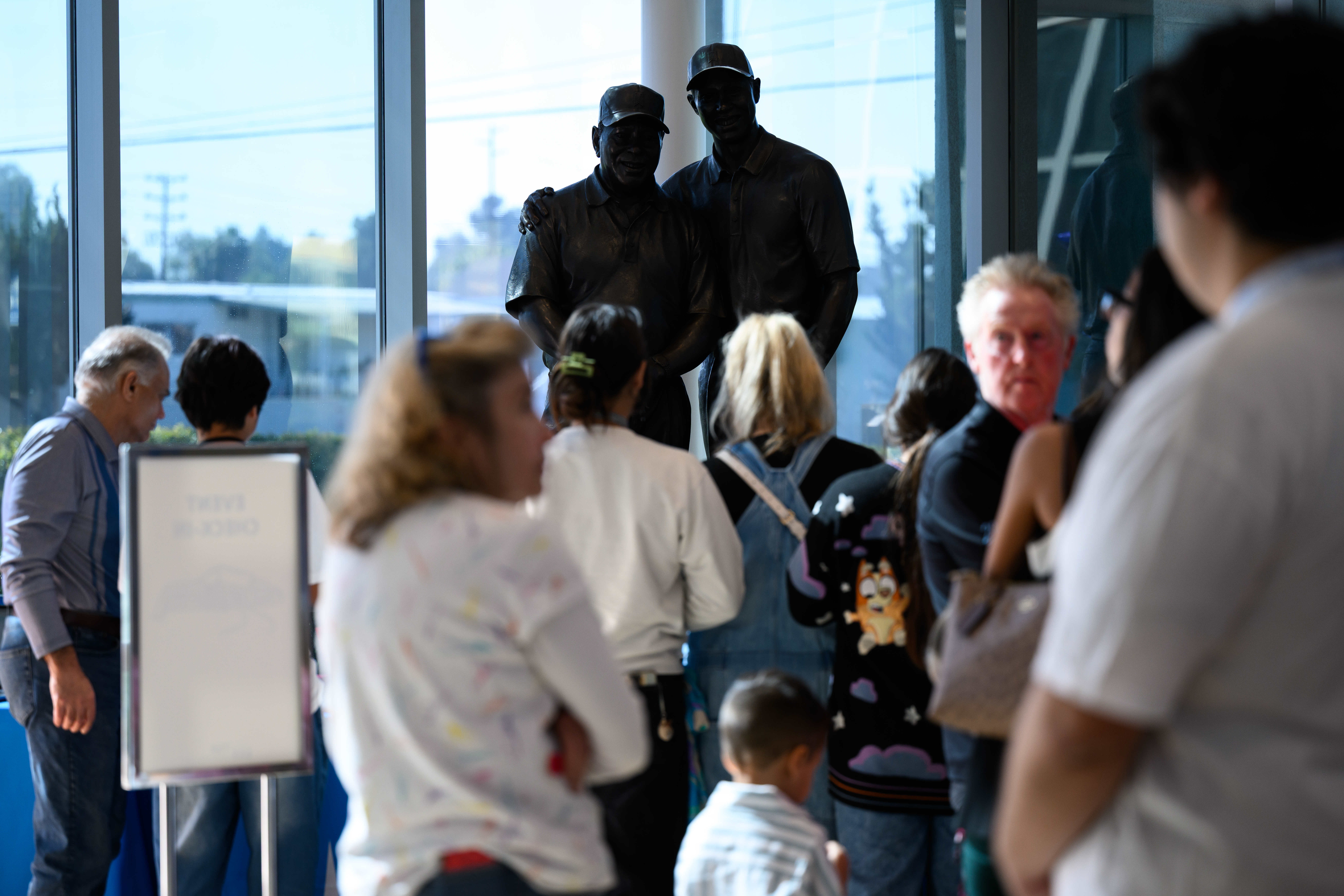 A statue of Earl and Tiger Woods overlooks visitors during...