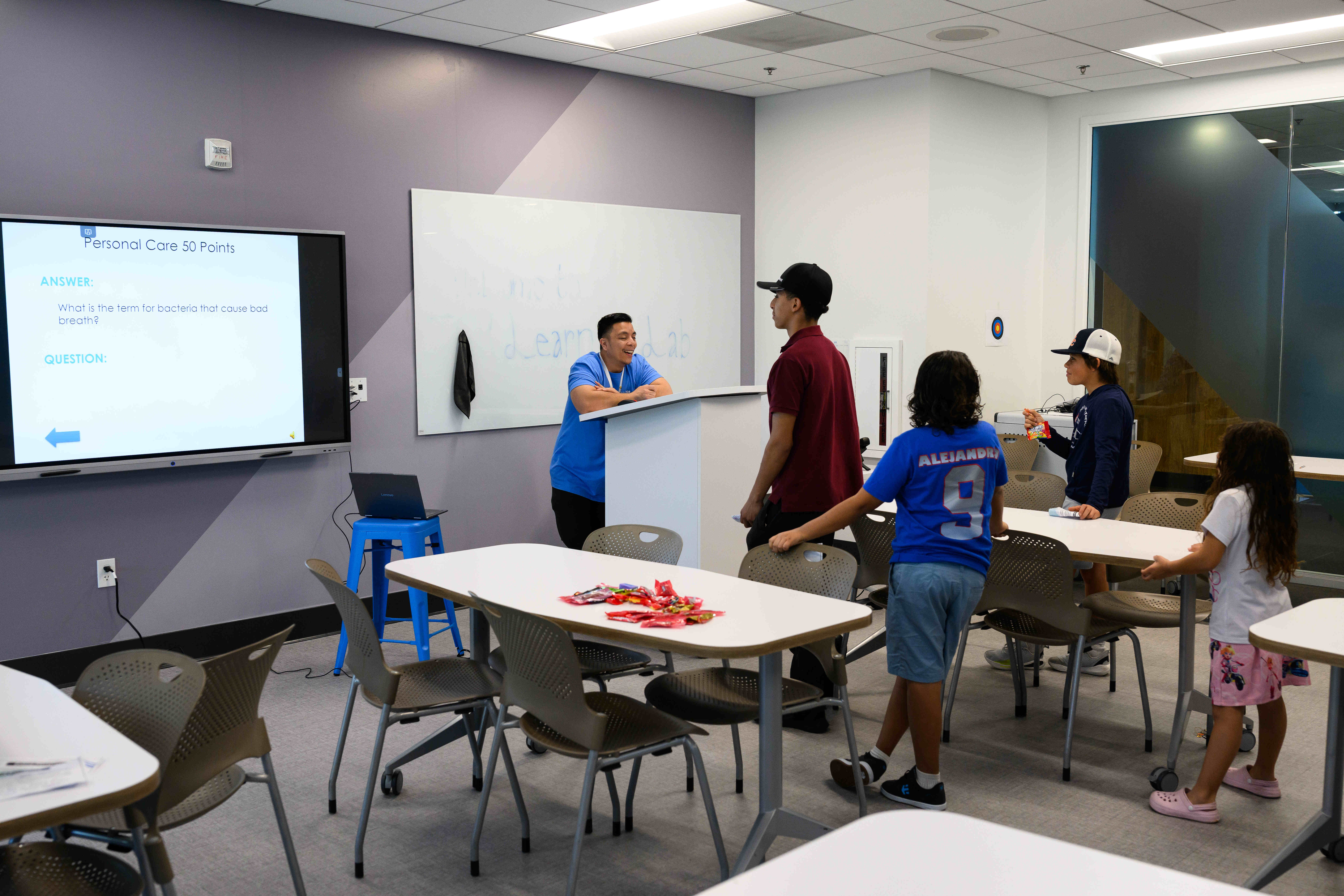 Students test their general knowledge in a quiz game during...