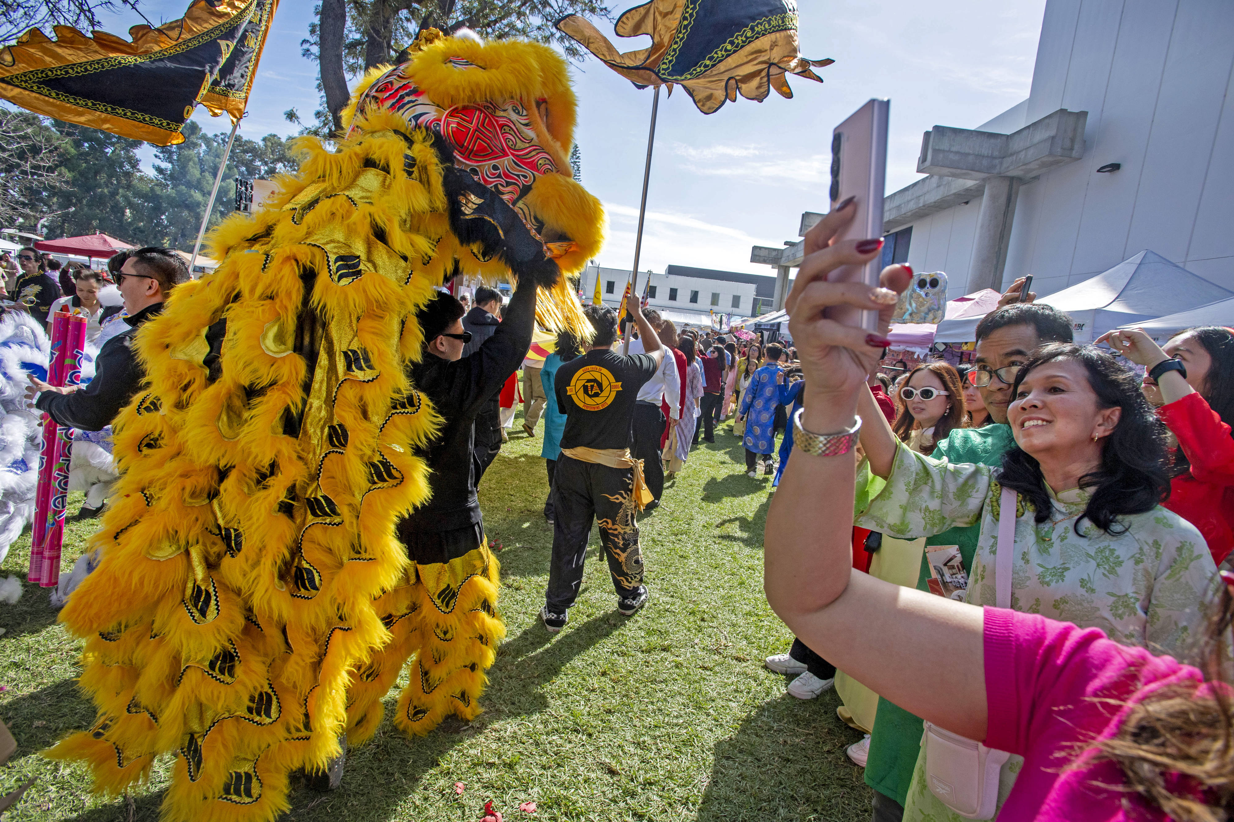 Dragon dancers make their way through the UVSA Tet Festival,...