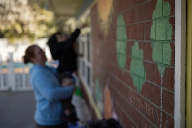 Amanda Smith, a behavioral specialist, tends to a child at Moore Learning Preschool & Childcare Center in Elk Grove on Feb. 6, 2026. (Miguel Gutierrez Jr., CalMatters)